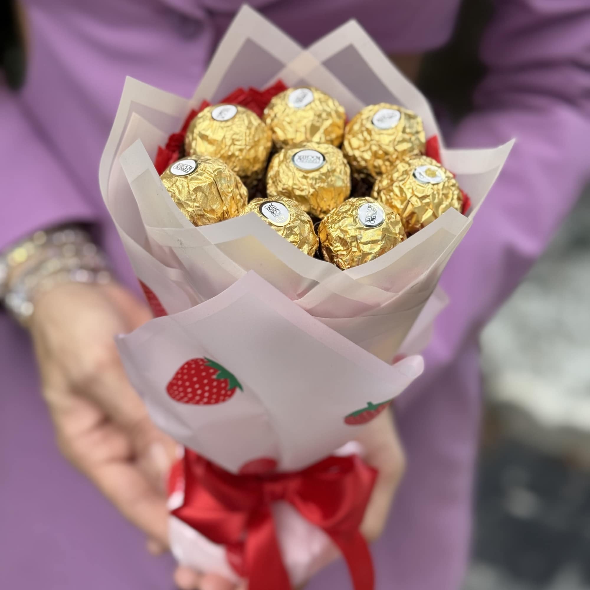 Glistening gold Ferrero Rocher chocolates artfully arranged like a hand-tied bouquet give, photo 2 of 3