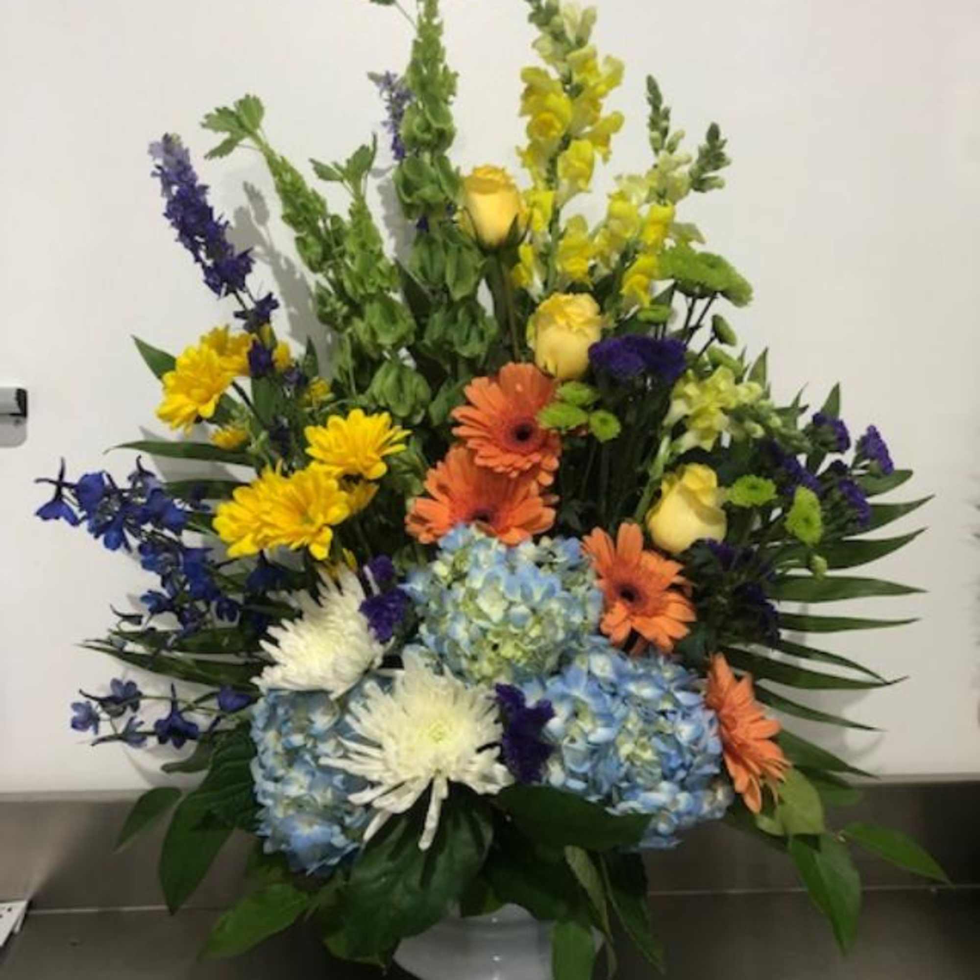 Colorful mixed flower arrangement in a white vase, photo 2 of 2