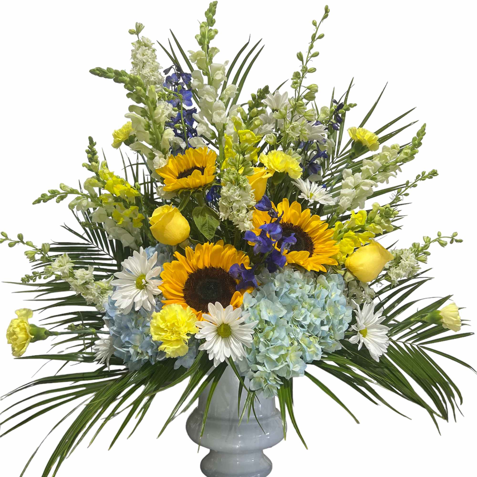 Mixed bouquet of sunflowers, hydrangeas, and daisies in a gray vase