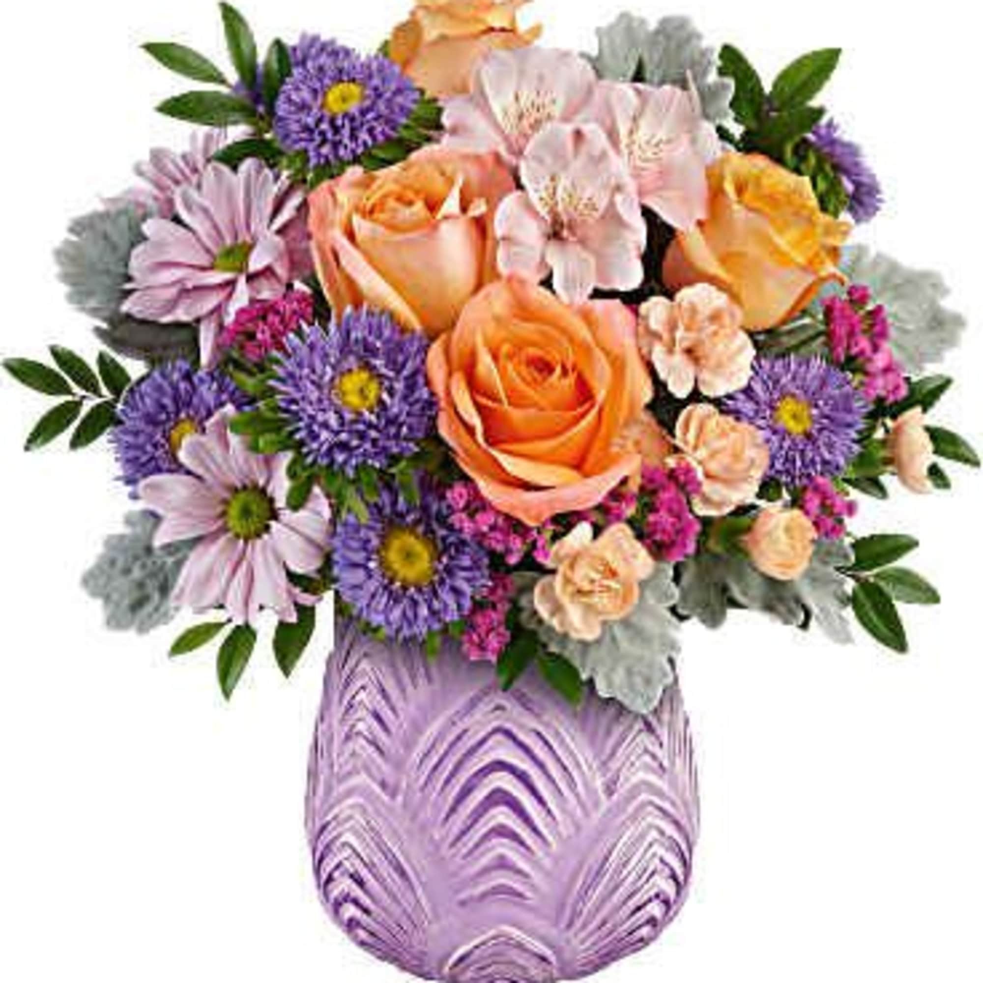 Bouquet of orange roses and purple daisies in a lavender vase