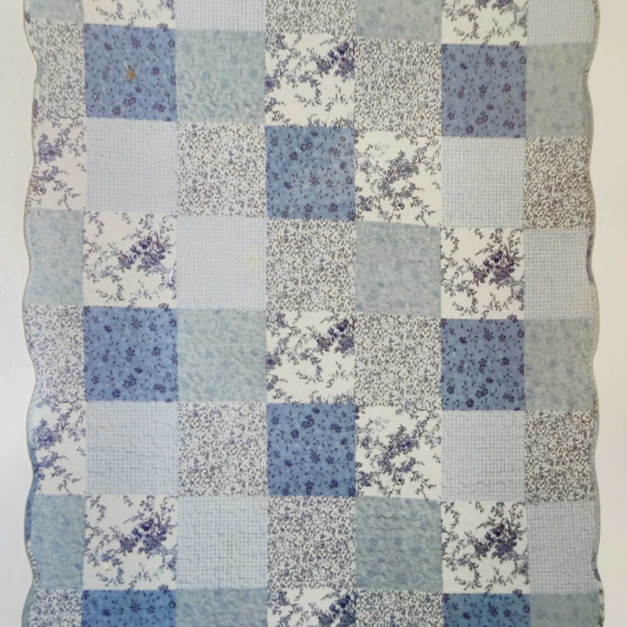 Blue and white patchwork quilt with floral prints