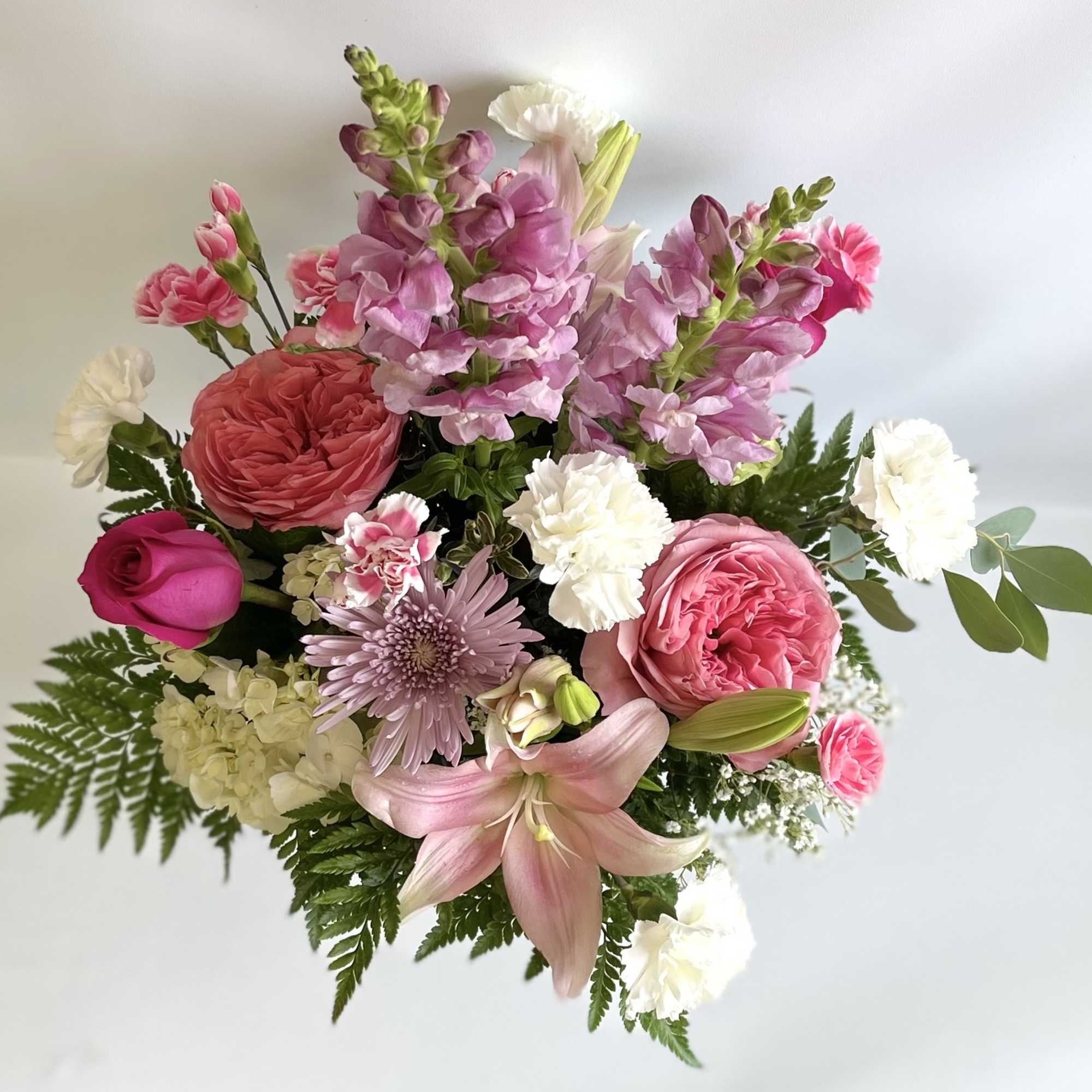Mixed bouquet with pink roses, lilies, snapdragons, and white carnations