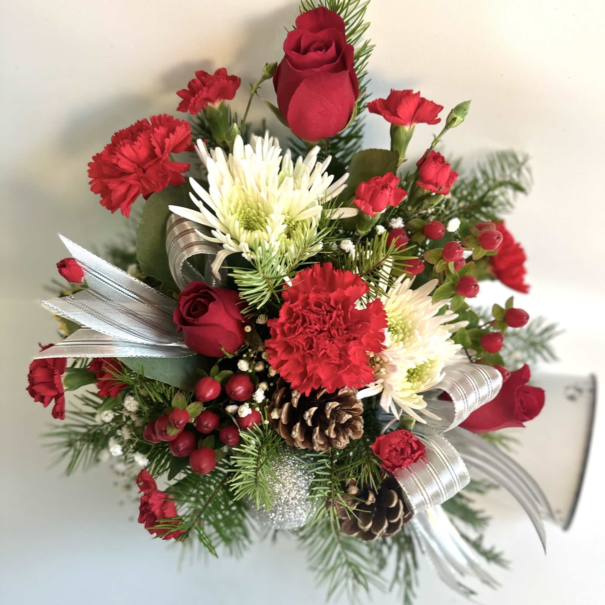 Red roses and carnations with white chrysanthemums in a festive bouquet