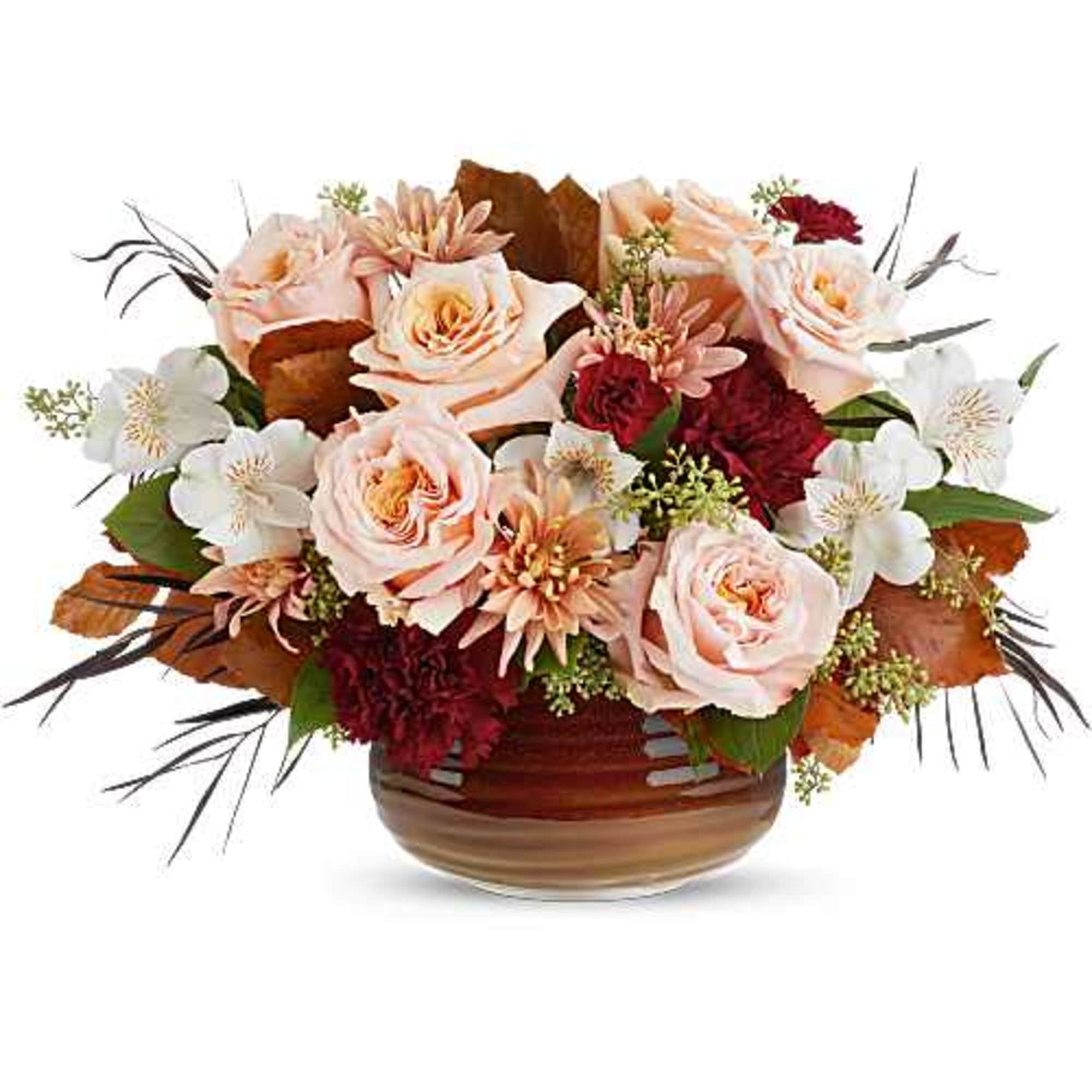 Teleflora's Sunset Stone Centerpiece glows with rich reds and soft peach tones