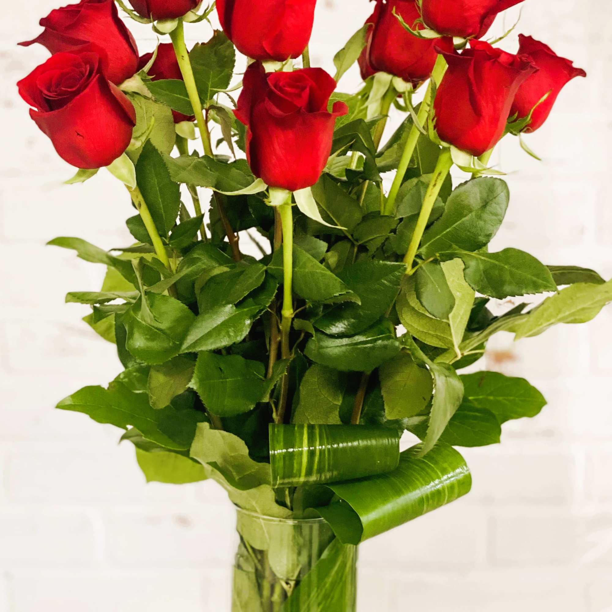 Bouquet of red roses in a clear glass vase