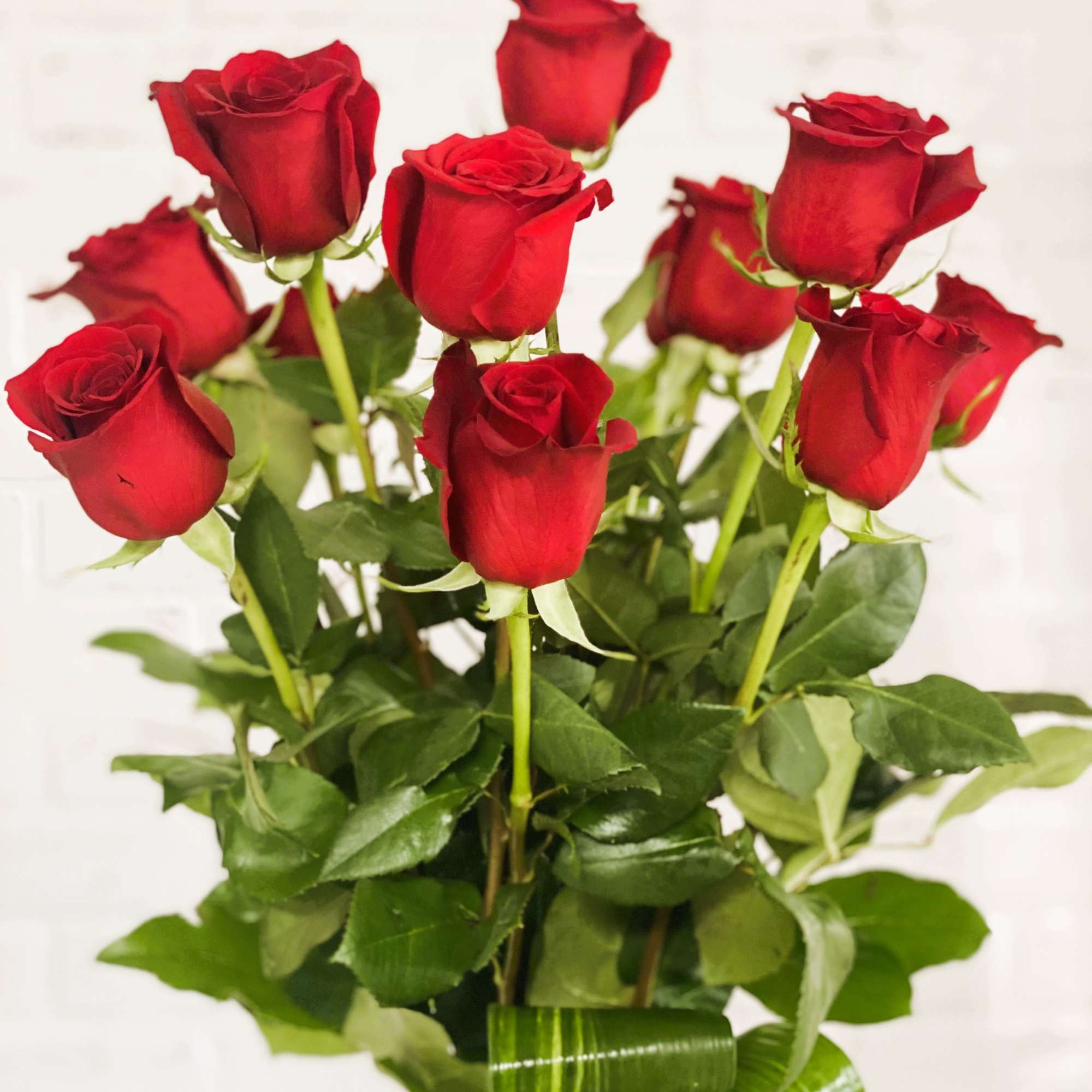 Bouquet of red roses in a clear glass vase, photo 2 of 3