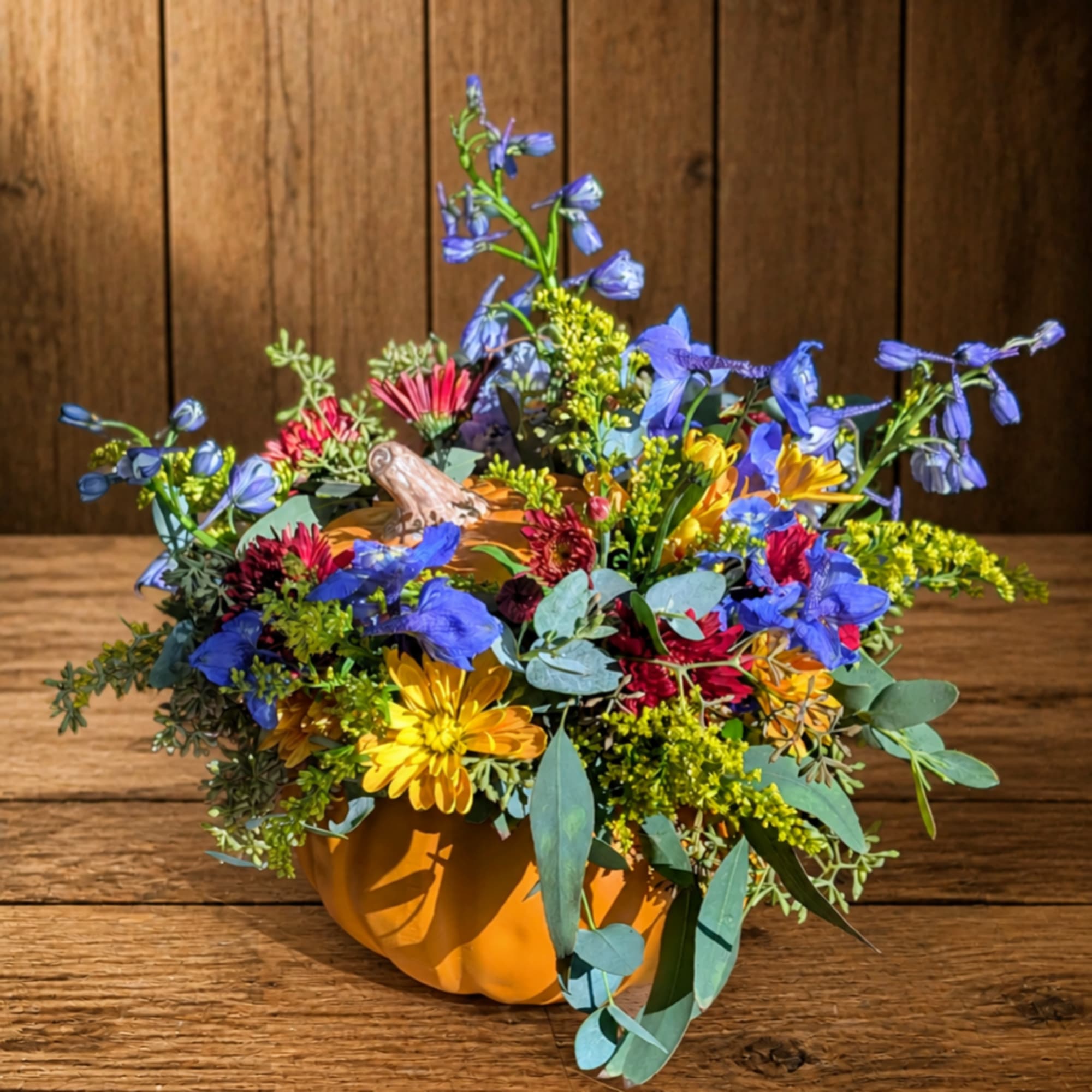 Mixed flower arrangement in a pumpkin-shaped container