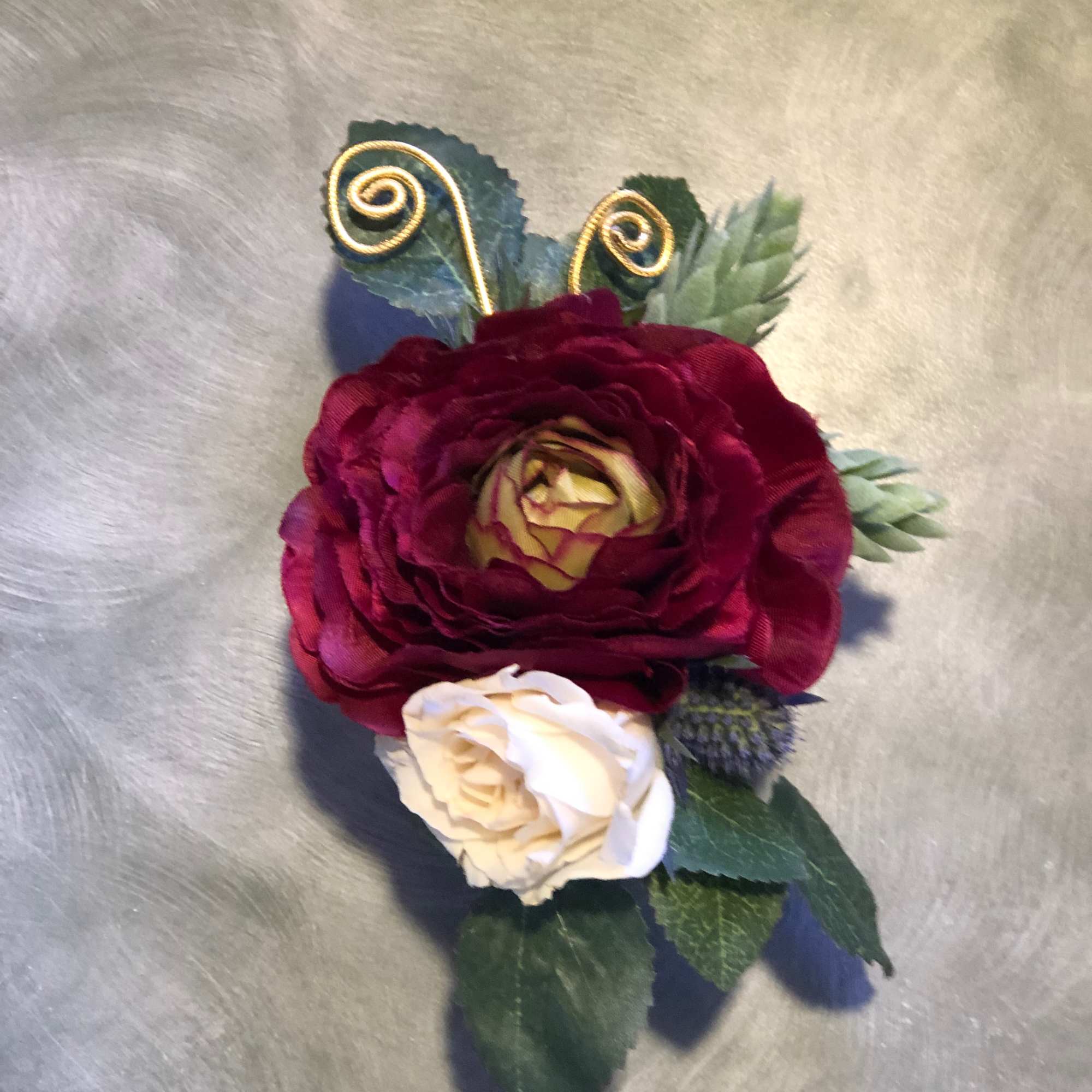 Small floral corsage with burgundy and cream roses