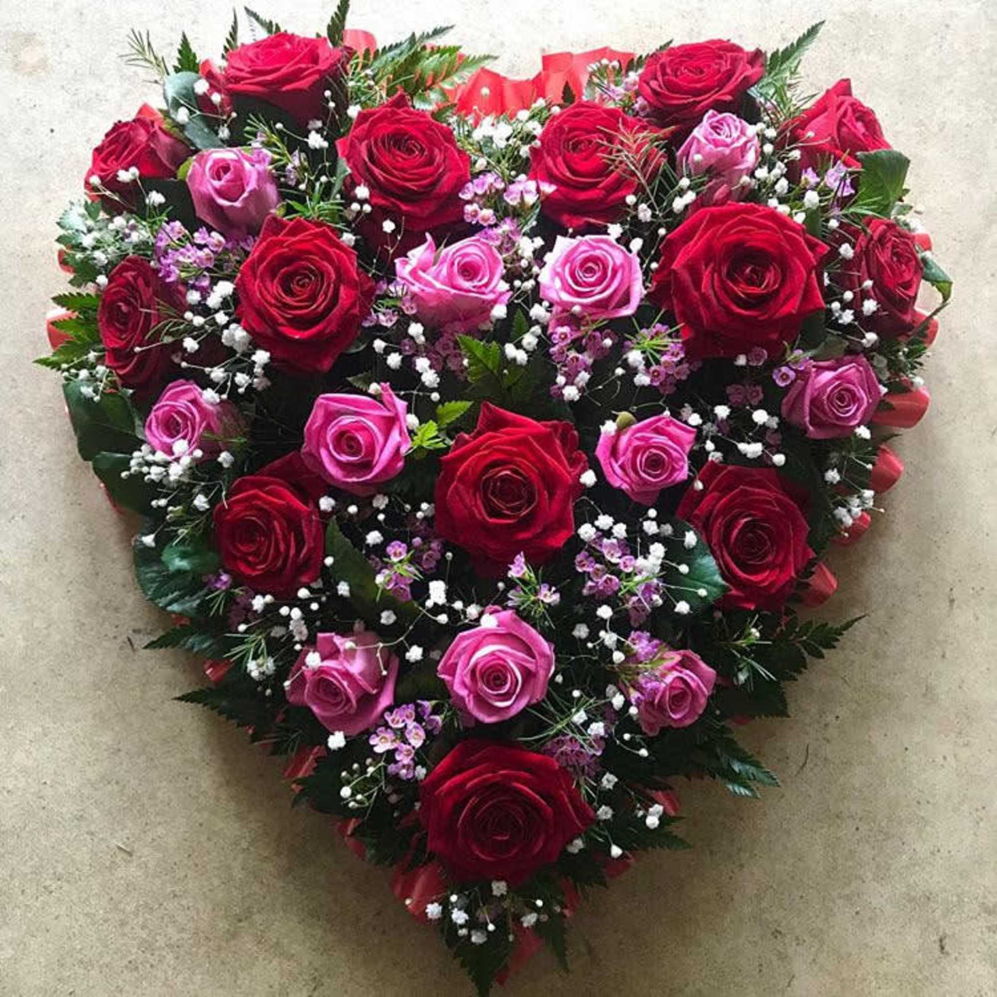 Heart-shaped bouquet of red and pink roses