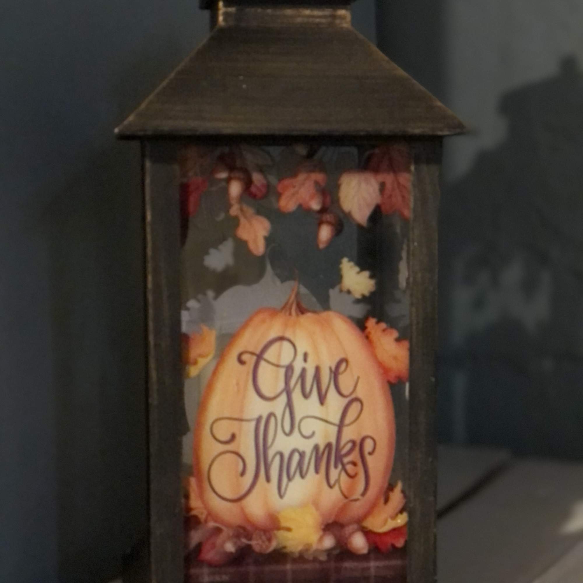 Decorative lantern with a pumpkin and "Give Thanks" text