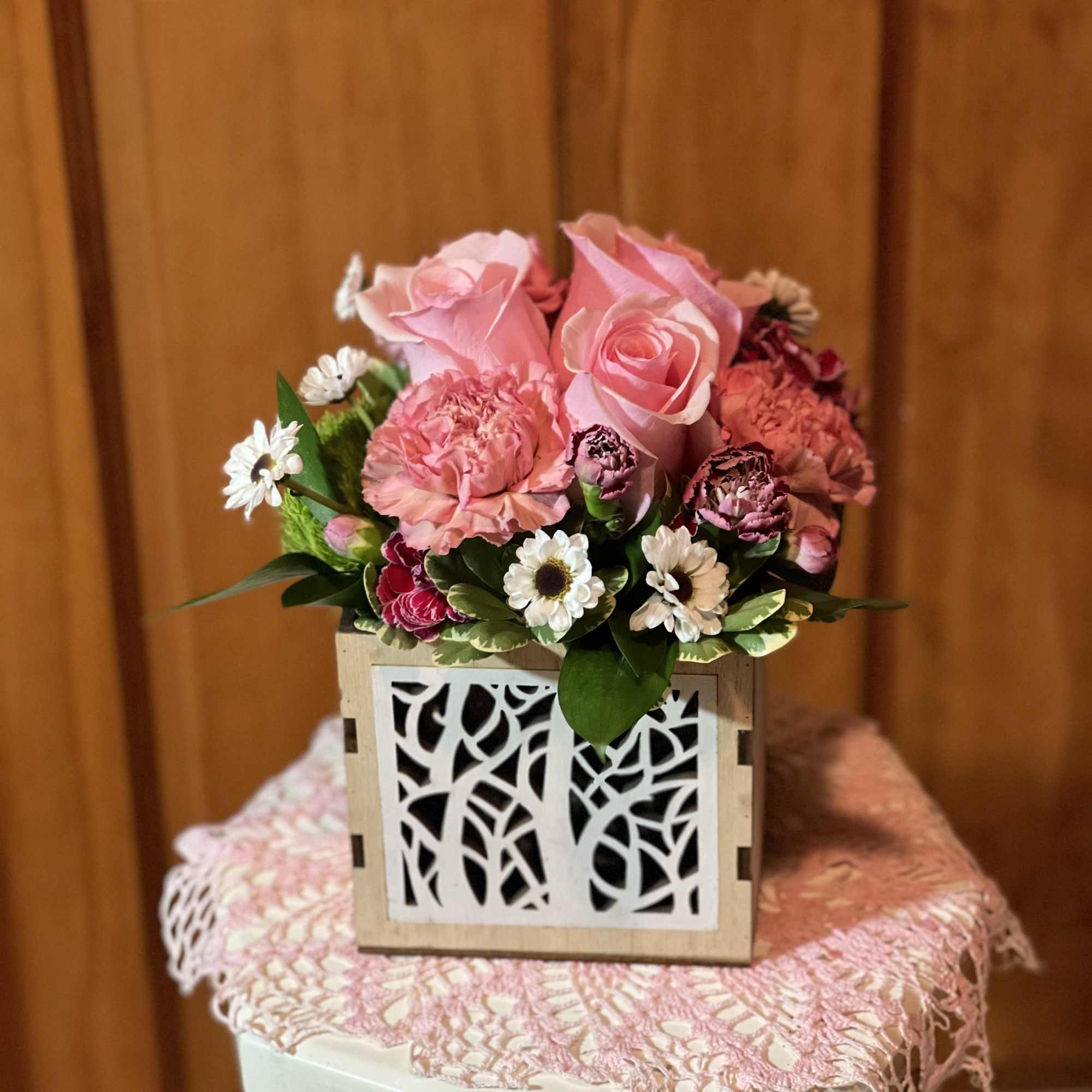 Pink rose and carnation arrangement in a decorative wooden box