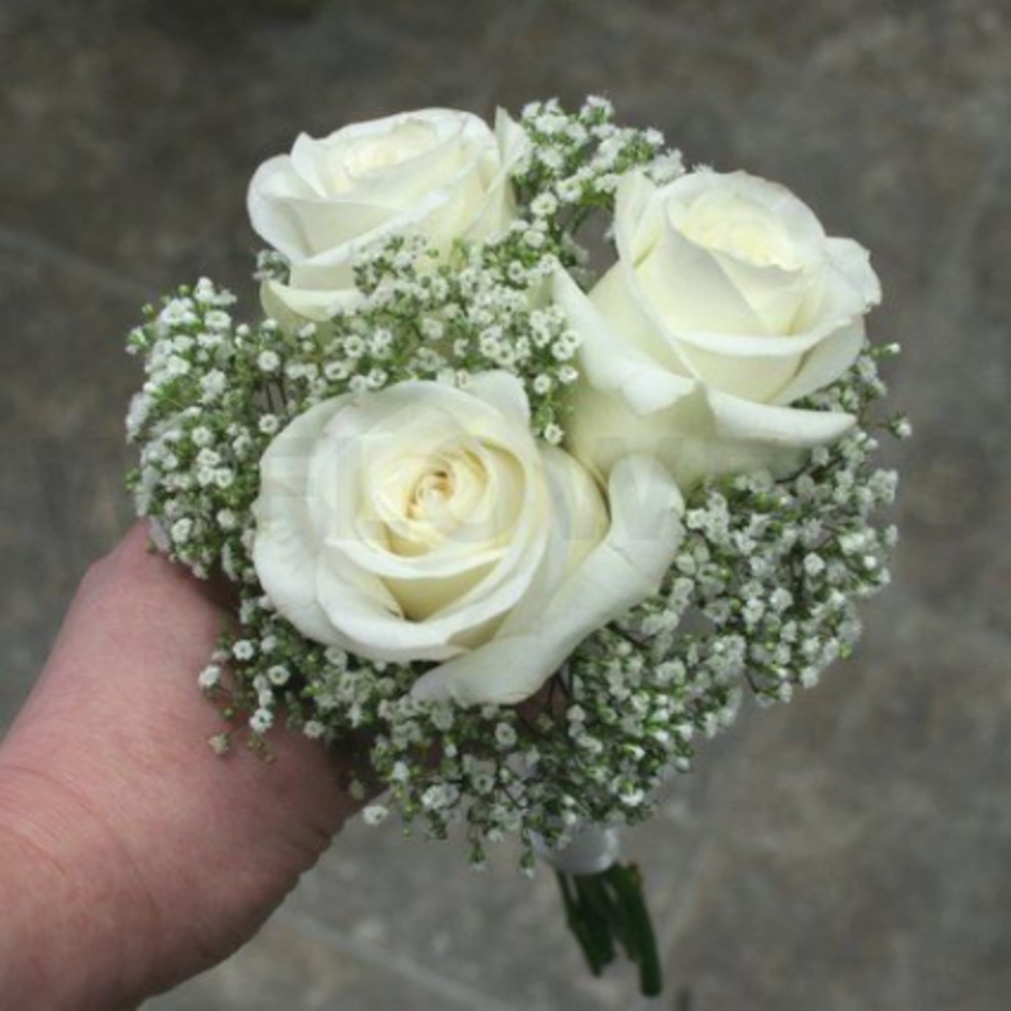 Small bouquet of white roses with baby's breath