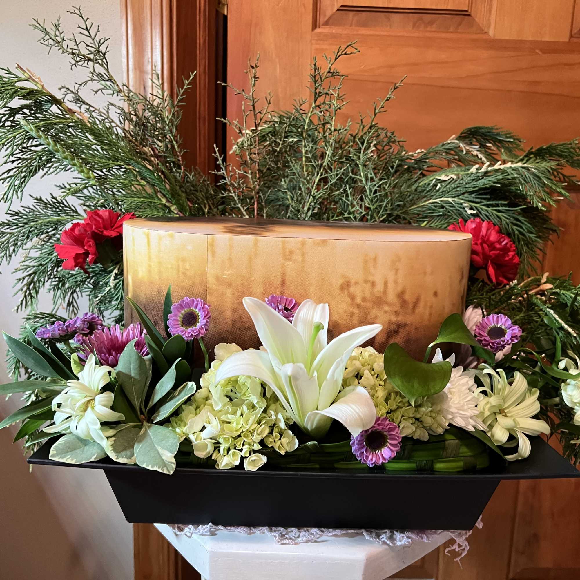 A low, dignified rectangular cremation arrangement that feels both elegant and quietly