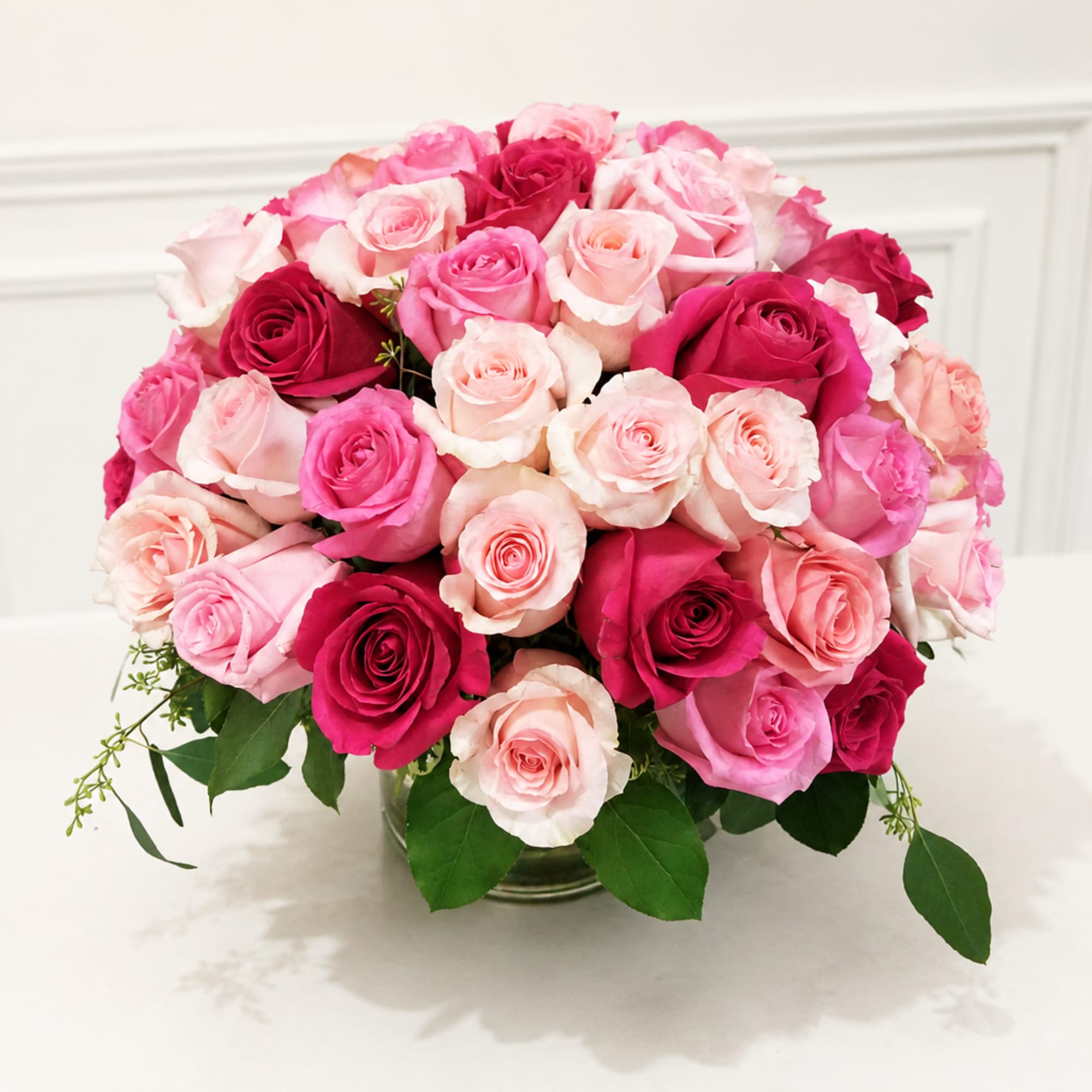 Bouquet of pink and red roses in a clear glass vase