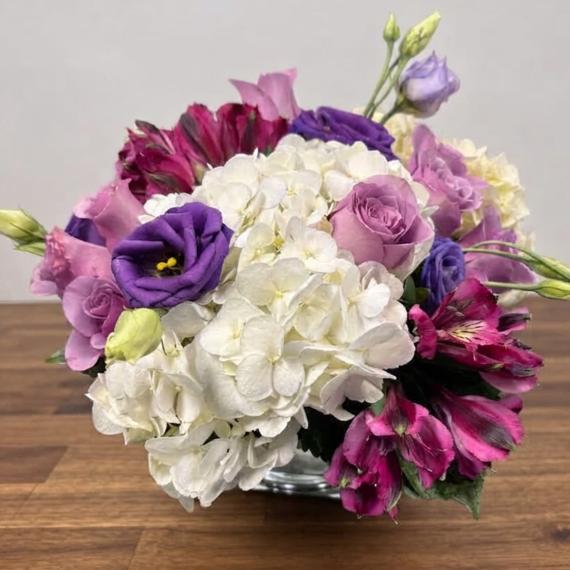 Bouquet of purple and white flowers in a glass vase