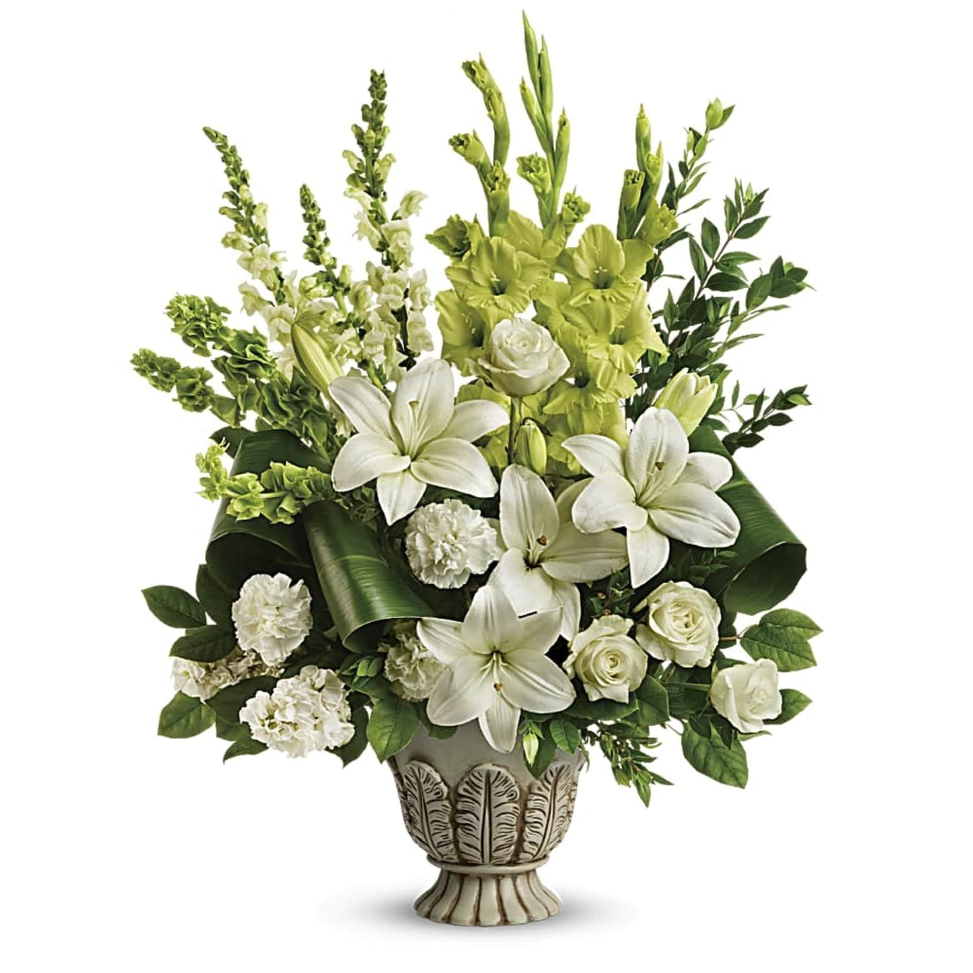 Tall white lily and rose arrangement in an ornate ivory urn vase