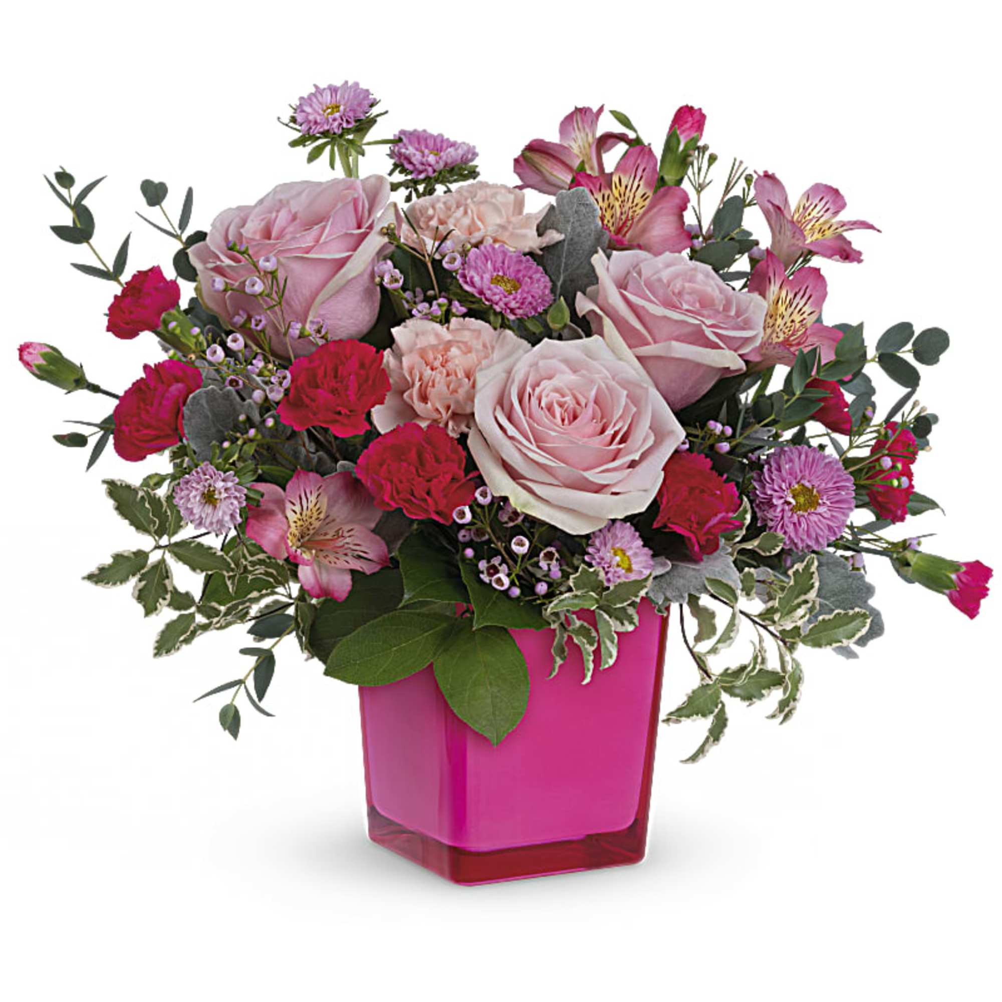Pink and red mixed flower arrangement with roses and carnations in a bright pink square vase