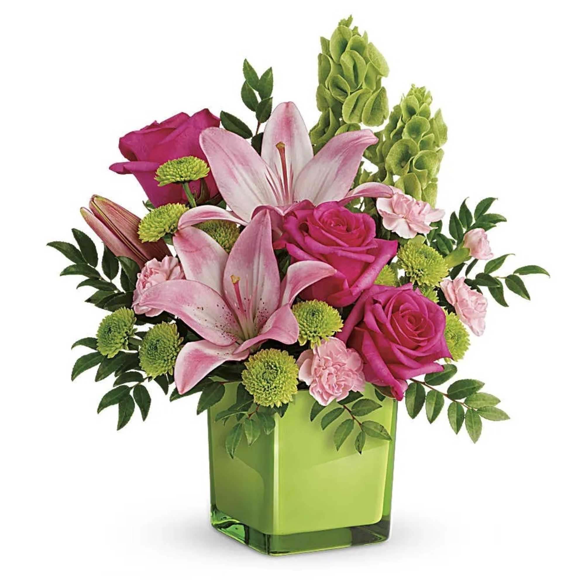 Pink lilies, roses, and green mums arranged in a bright green cube vase