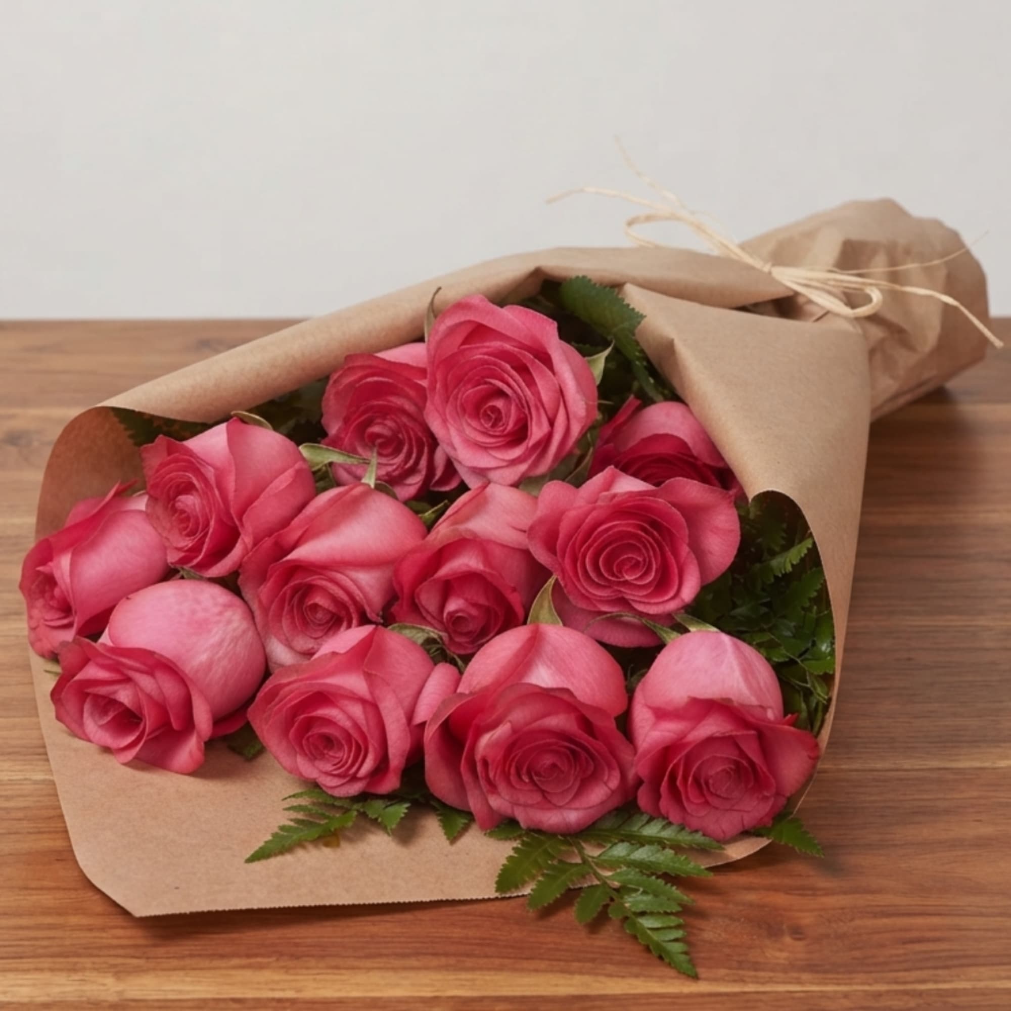Bouquet of pink roses wrapped in brown paper, photo 2 of 2