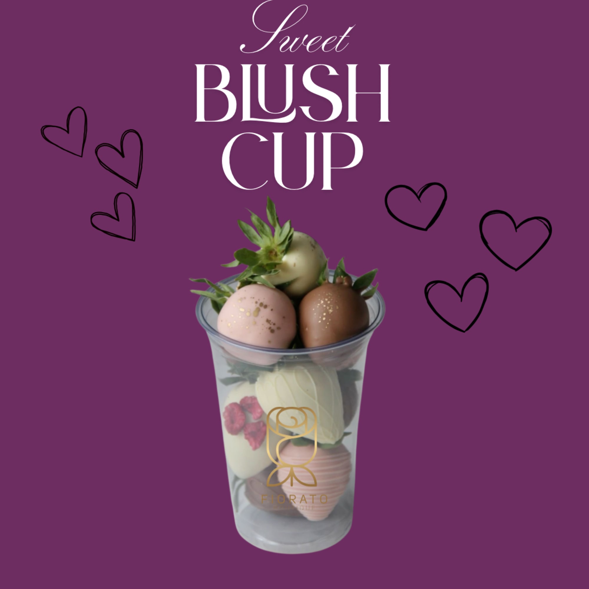 Chocolate-dipped strawberries in a clear cup with decorative hearts