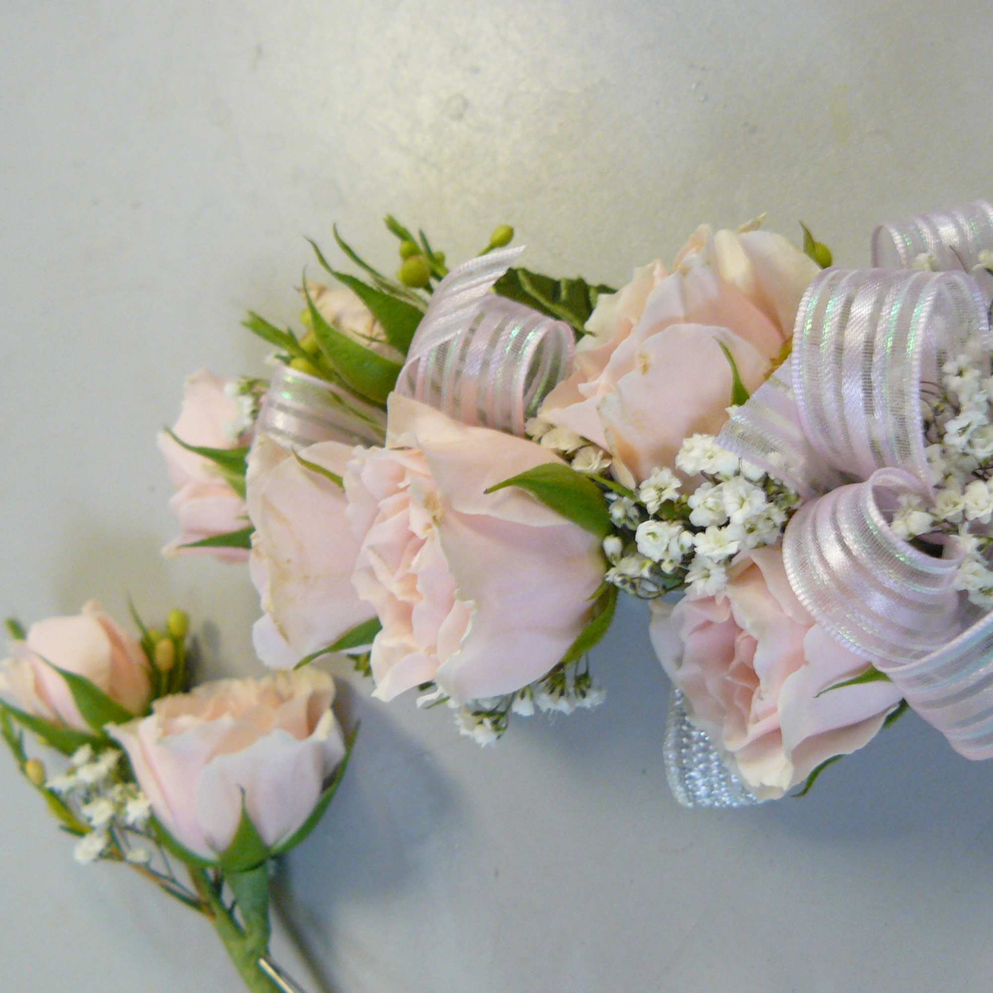 Blush rose corsage and boutonniere with ribbon and baby's breath