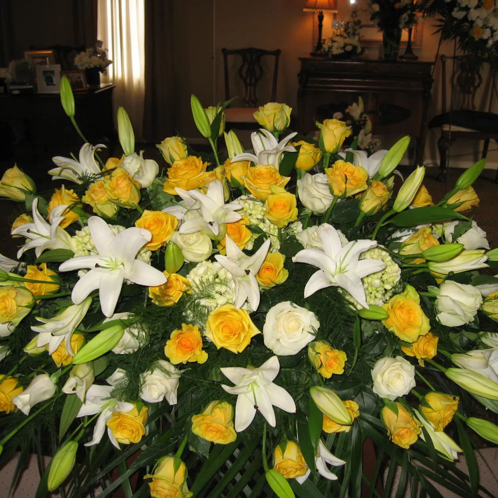 Large yellow and white floral spray with lilies and roses