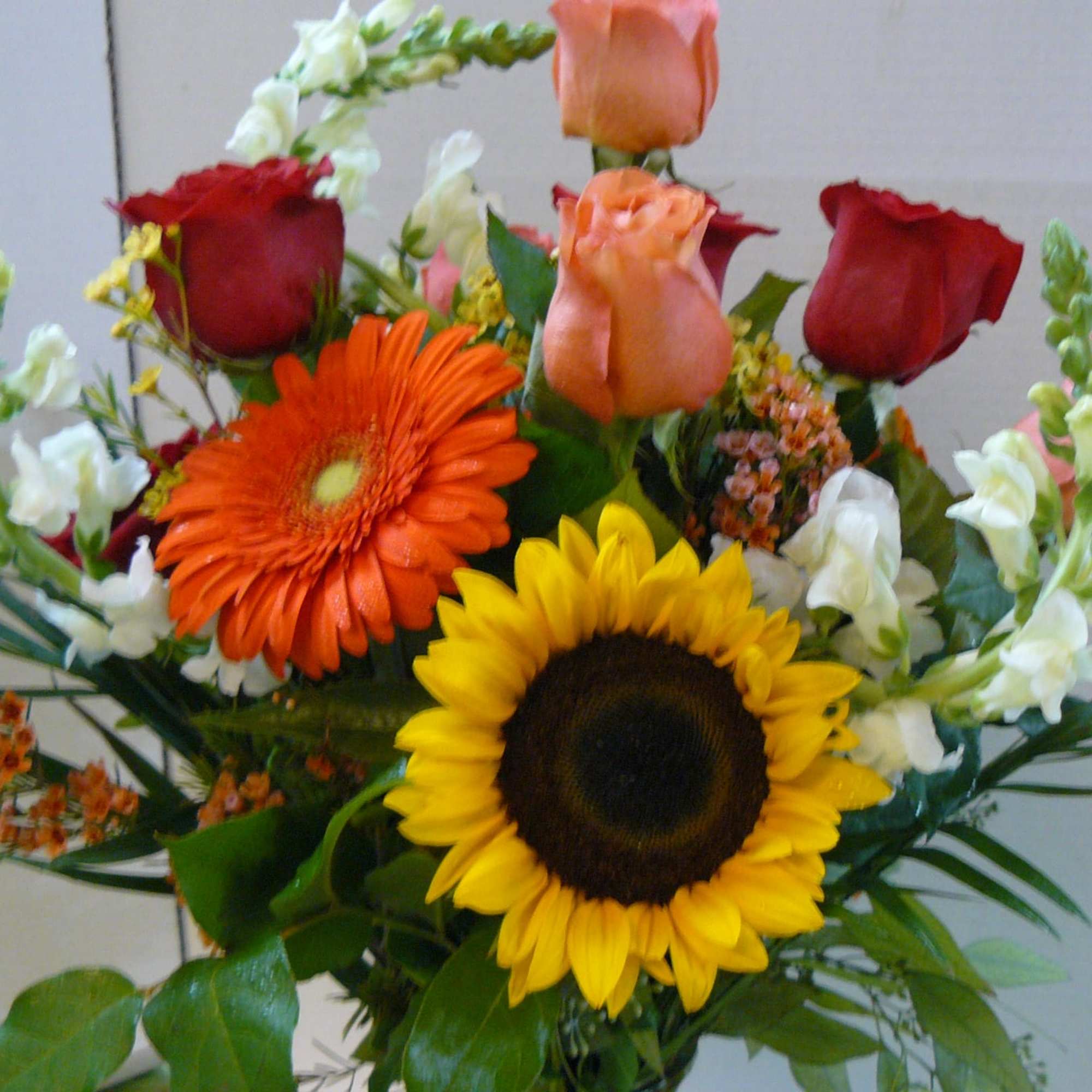 Mixed bouquet with sunflowers, roses, and gerbera daisies
