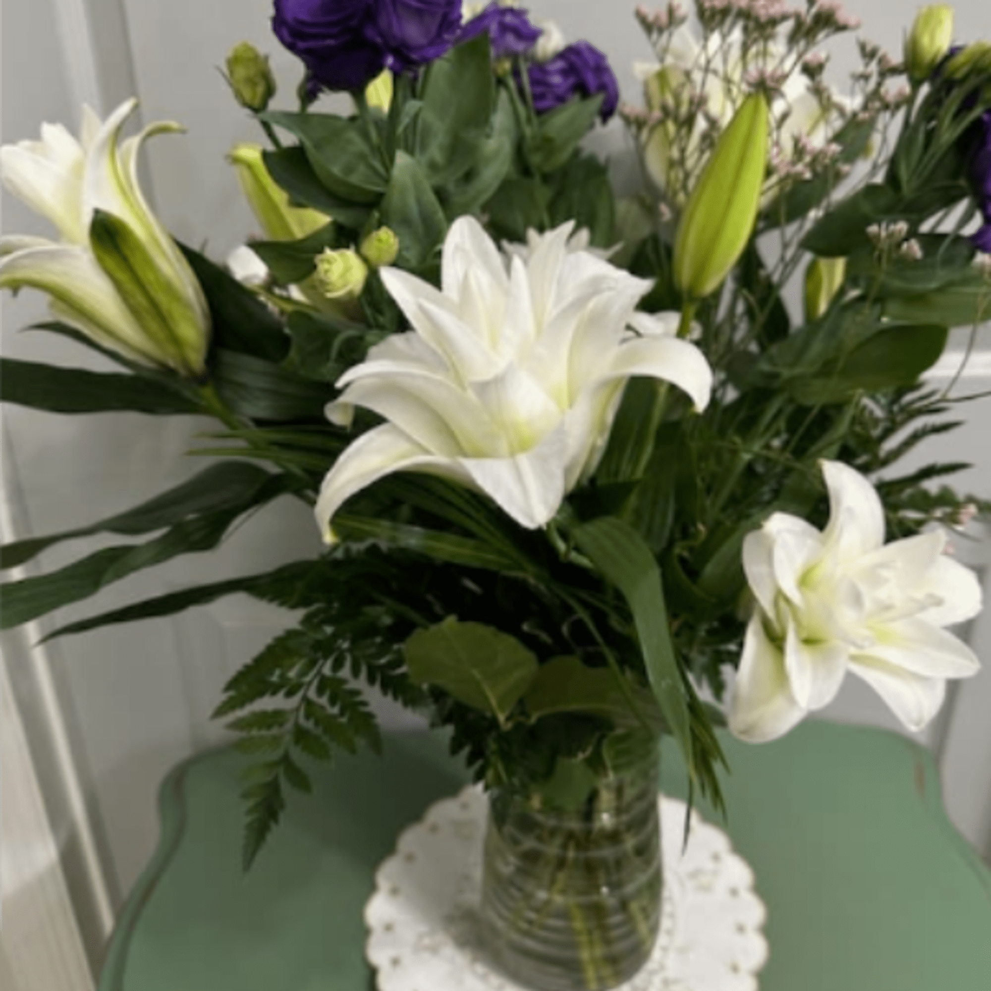 Large white lilies-some brushed with soft pink and green-meet clusters of deep