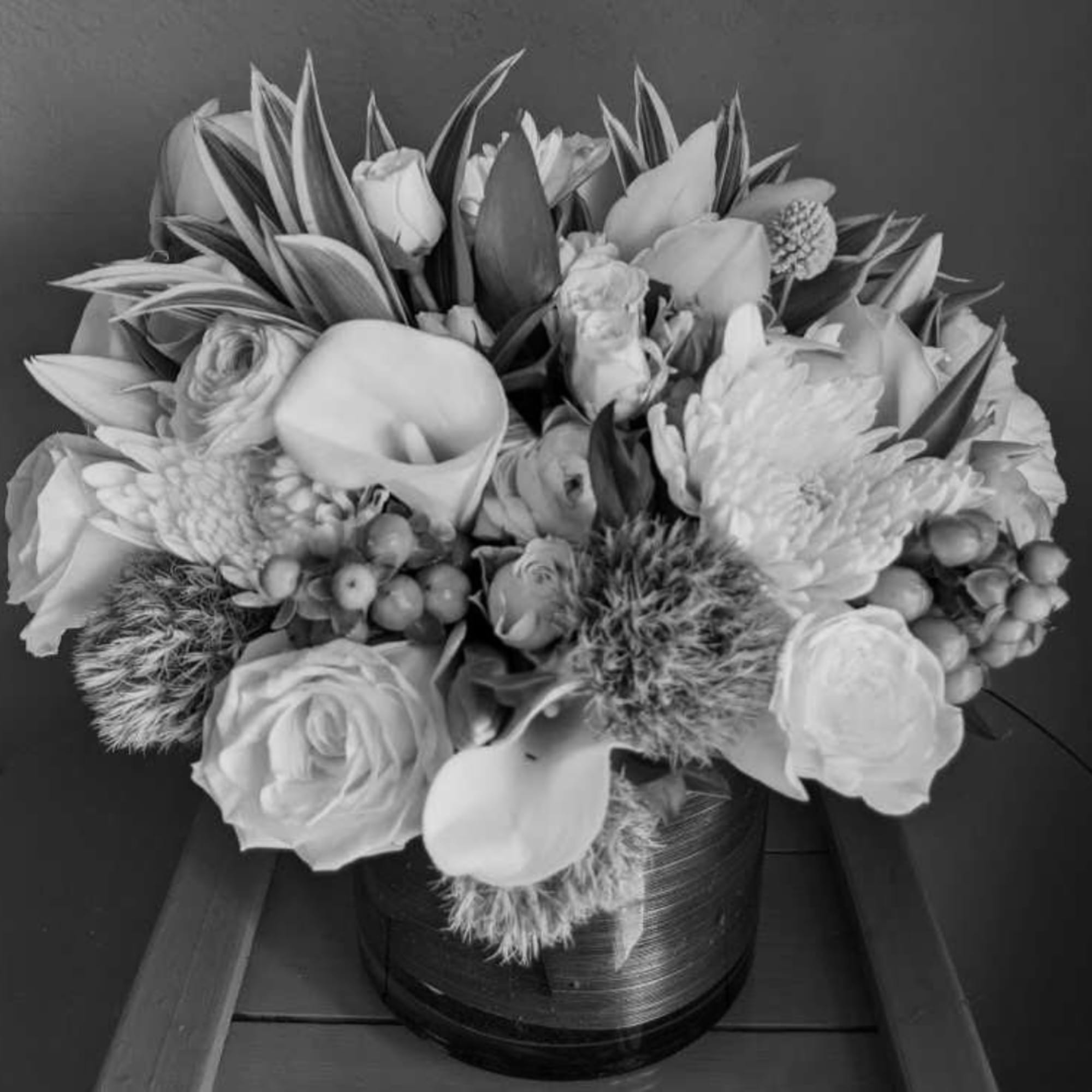 Large monochrome floral arrangement in a round vase