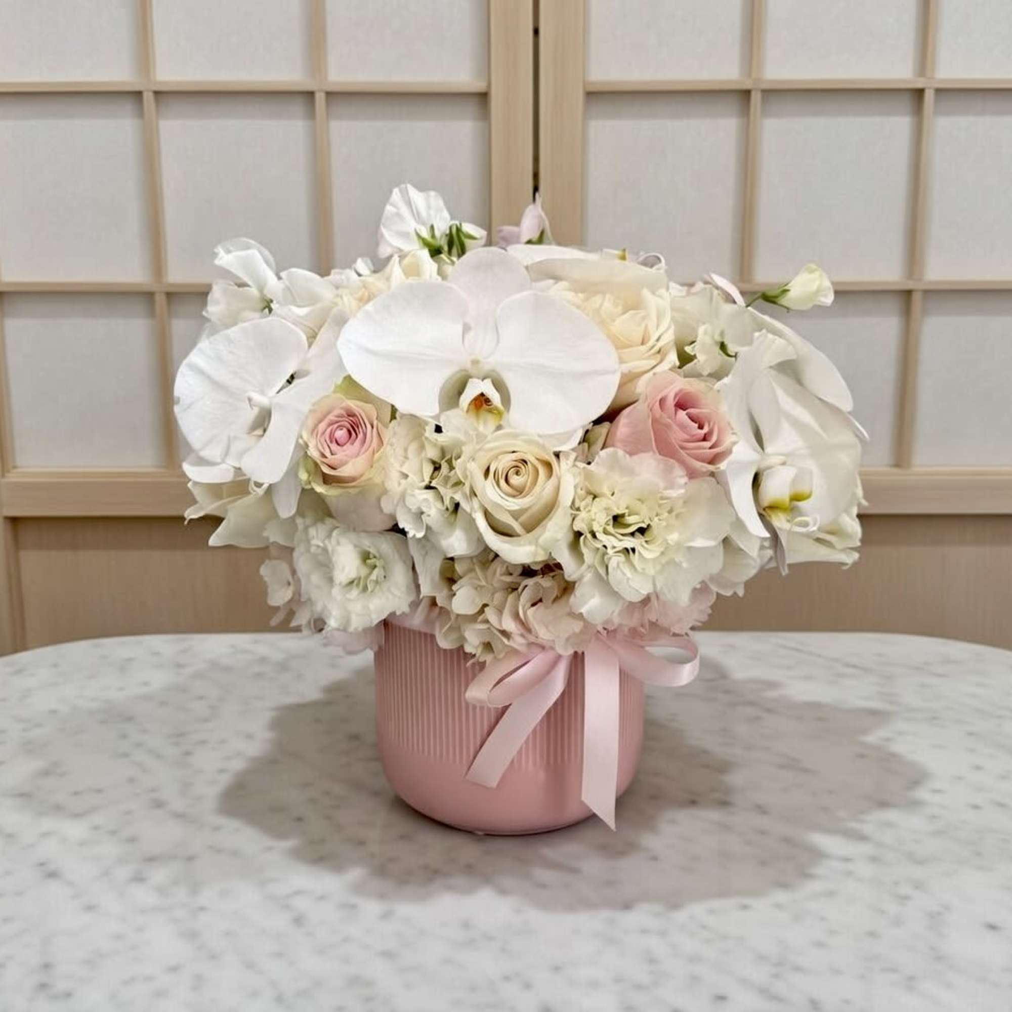 phalaenopses Orchid, premium Roses, Hydrangea, and Lisianthus in Ceramic vase.