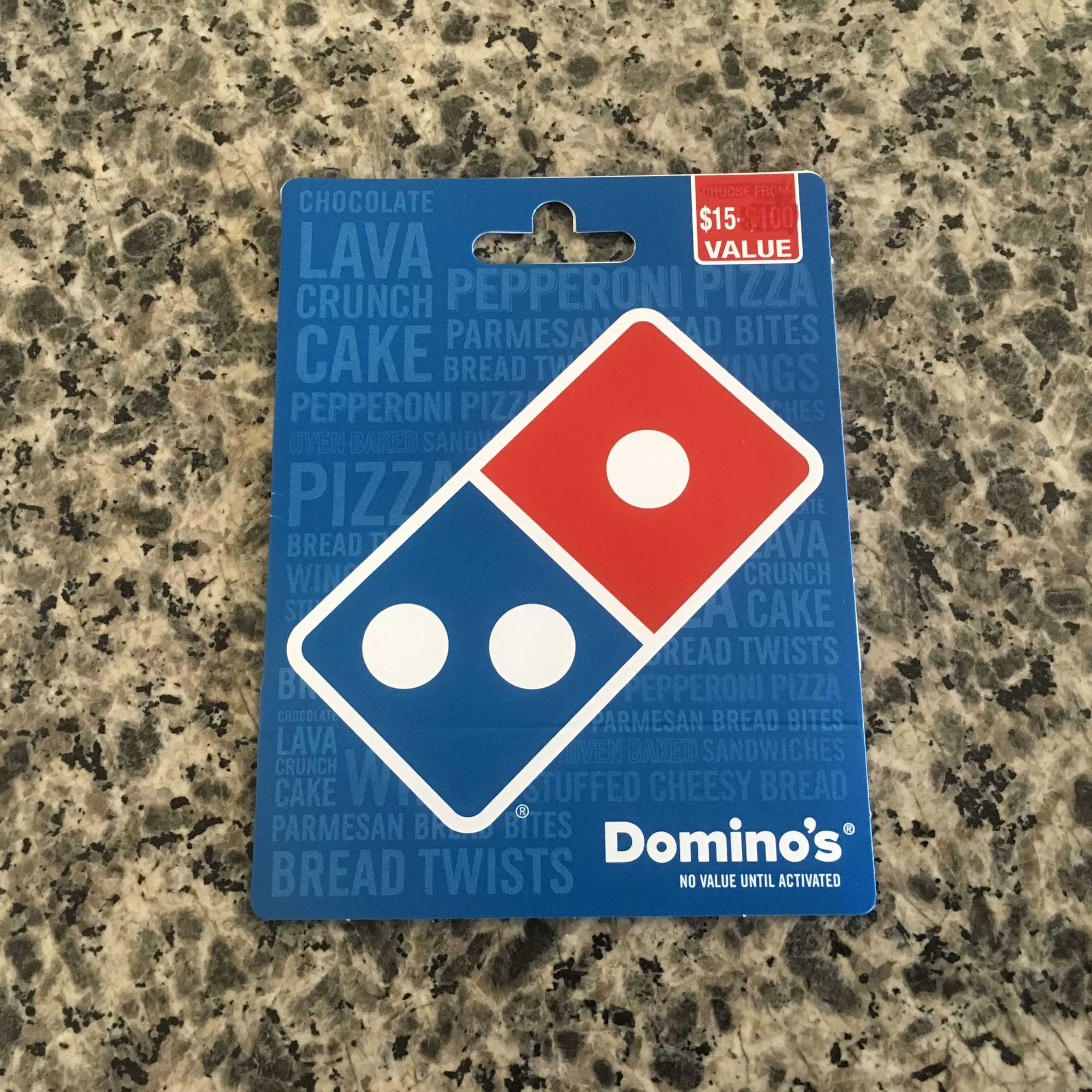 Domino's gift card on a speckled countertop