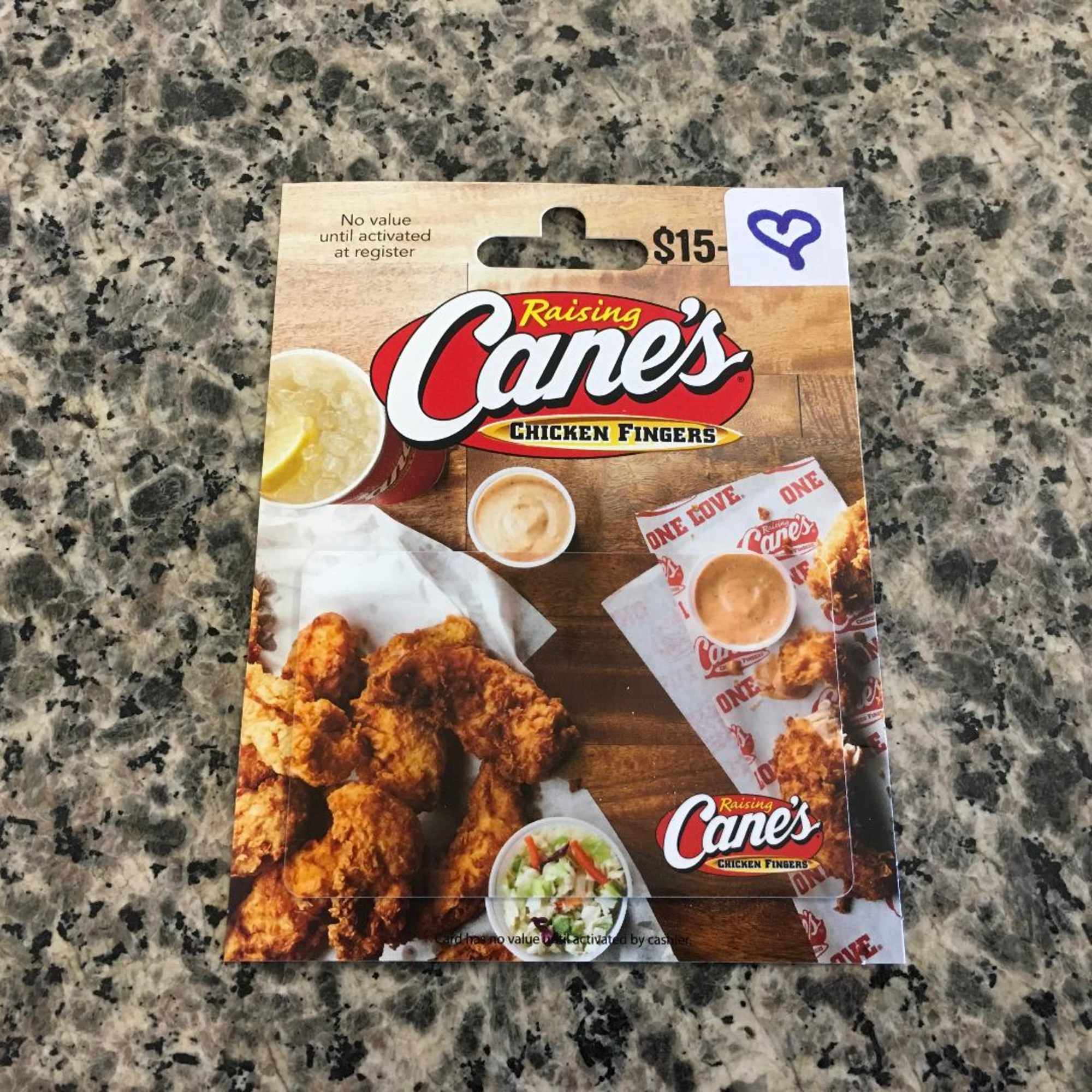 Raising Cane's $15 gift card on a granite countertop
