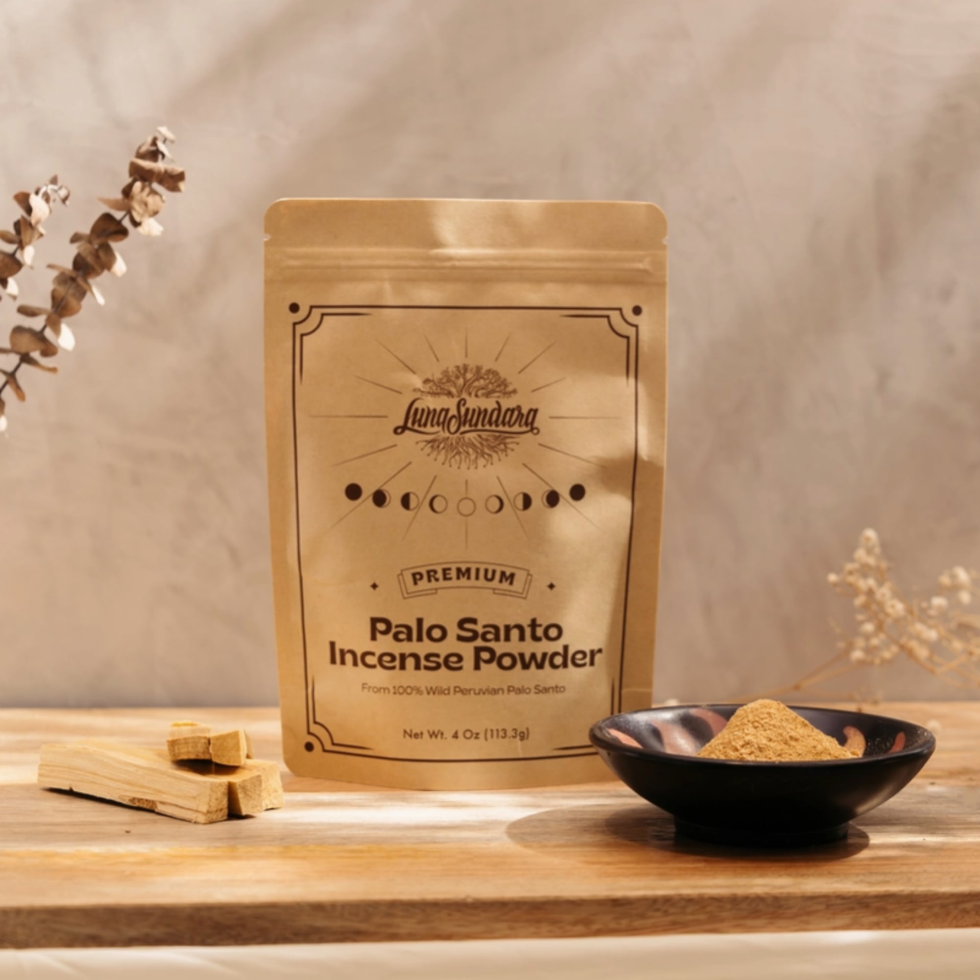 Palo Santo incense powder in a pouch with a small bowl and wood pieces
