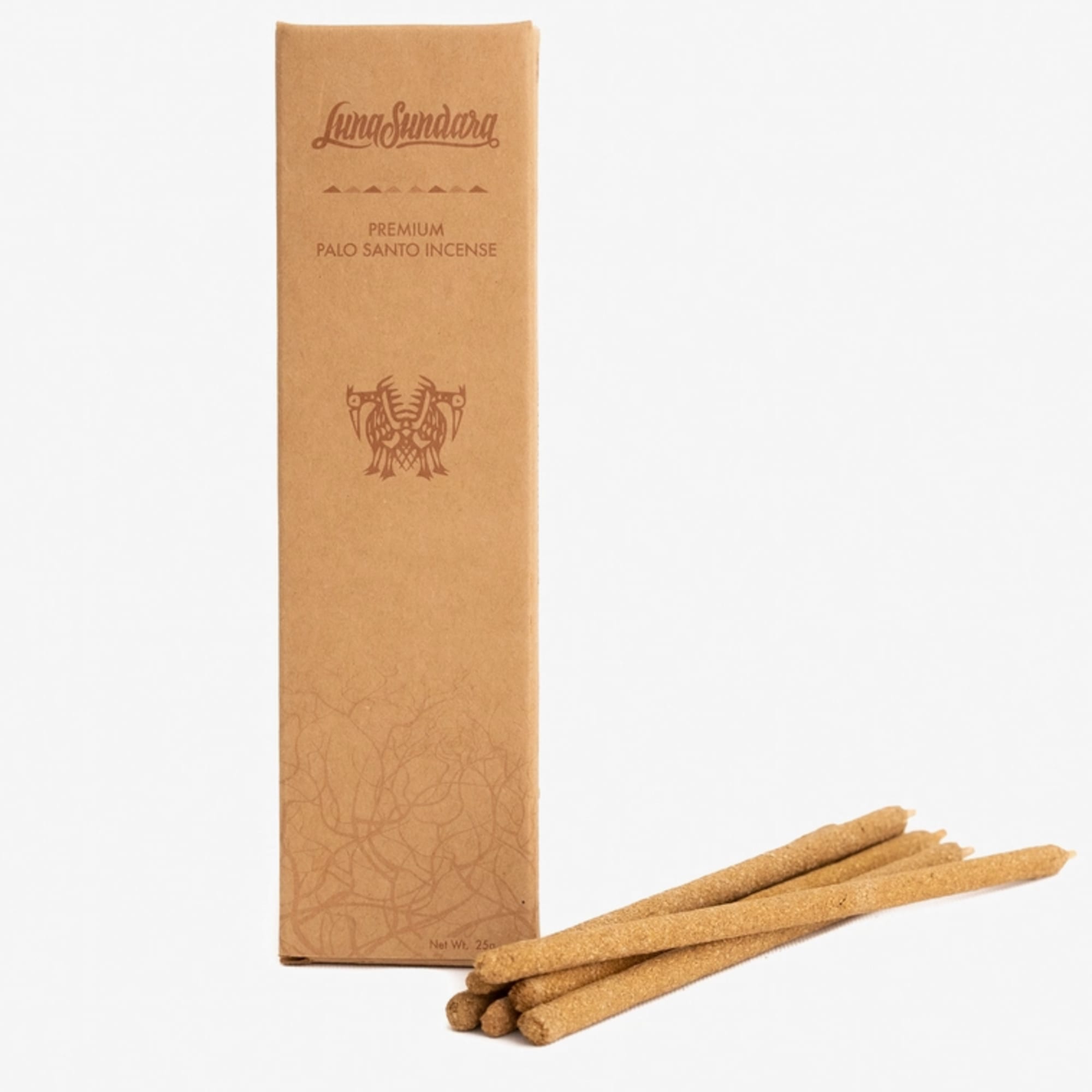 Box of palo santo incense sticks with several sticks beside it