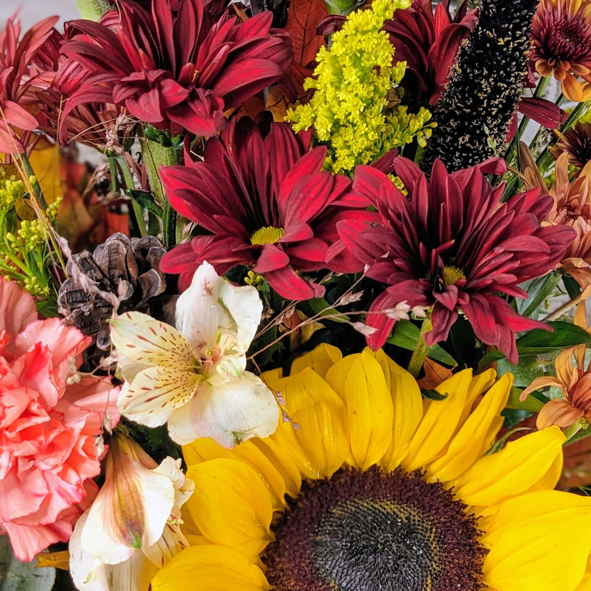 Mixed bouquet with sunflowers, carnations, and chrysanthemums in autumn colors