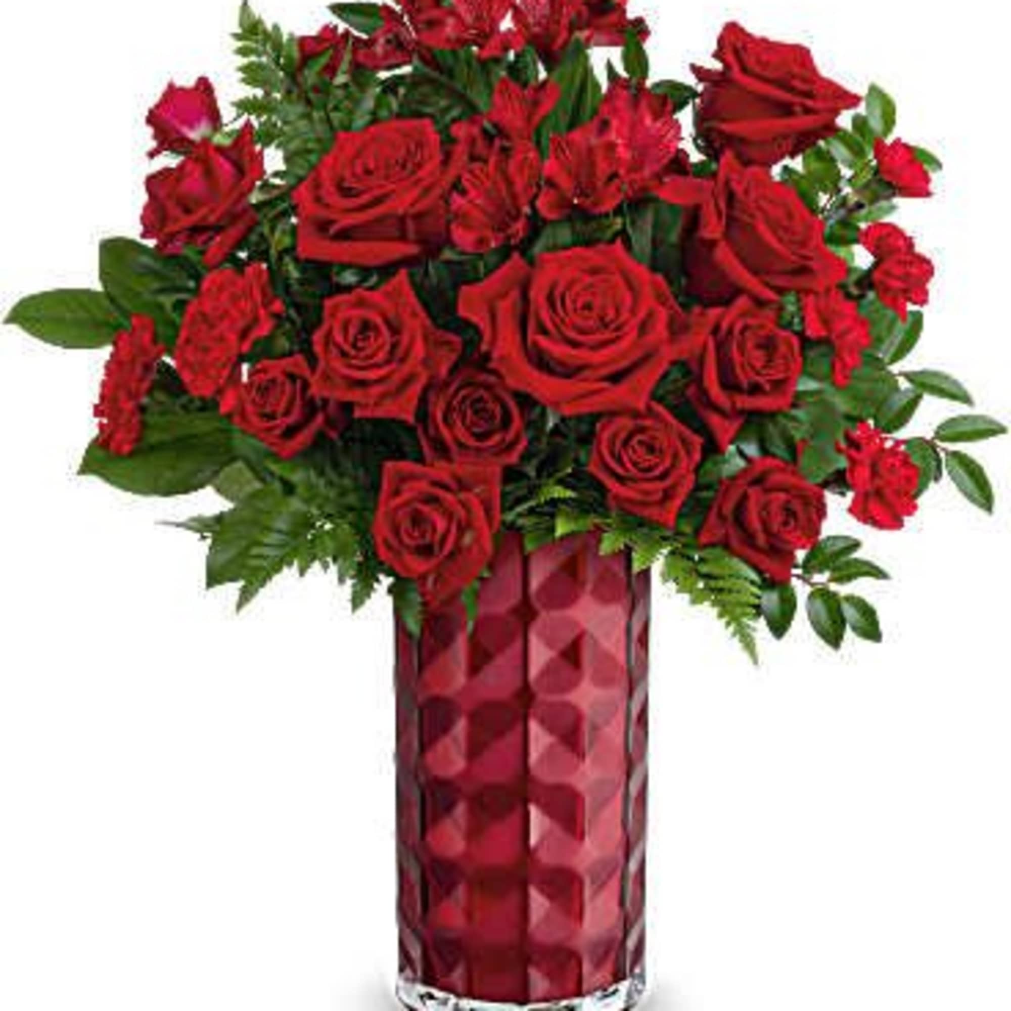 Red roses arranged in a tall red glass vase