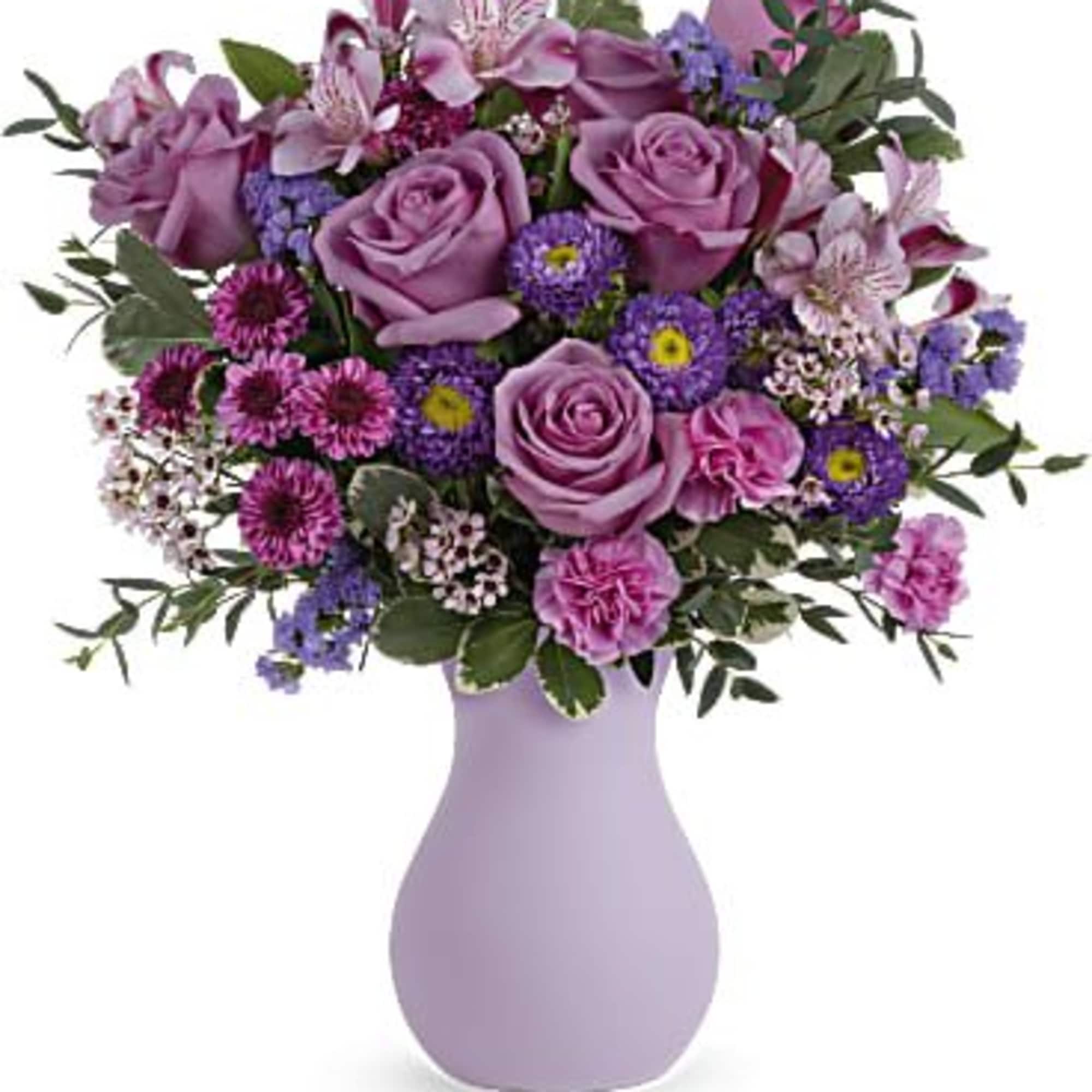 Pink and purple mixed bouquet in a lavender vase