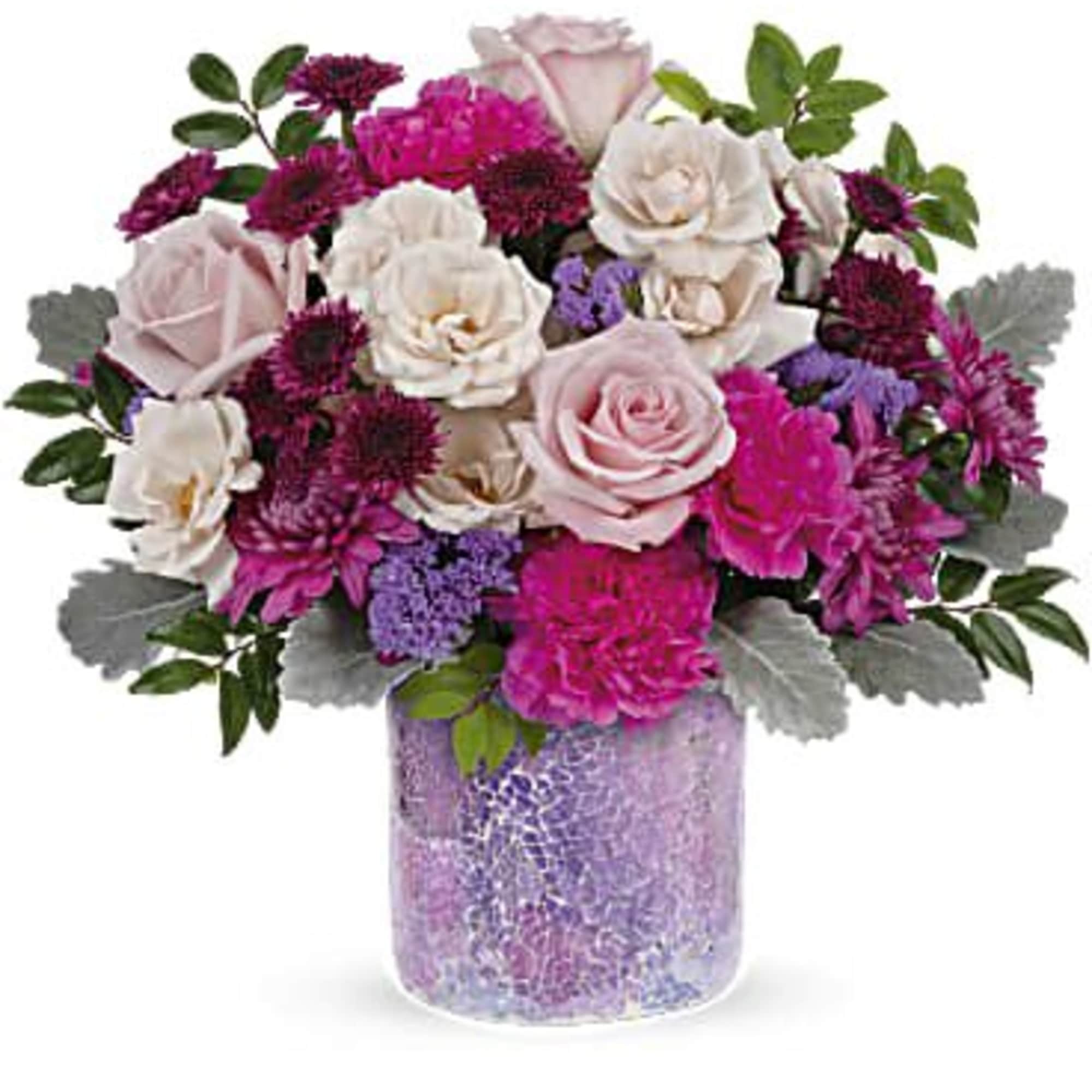 Pink and white rose bouquet in a purple glass vase