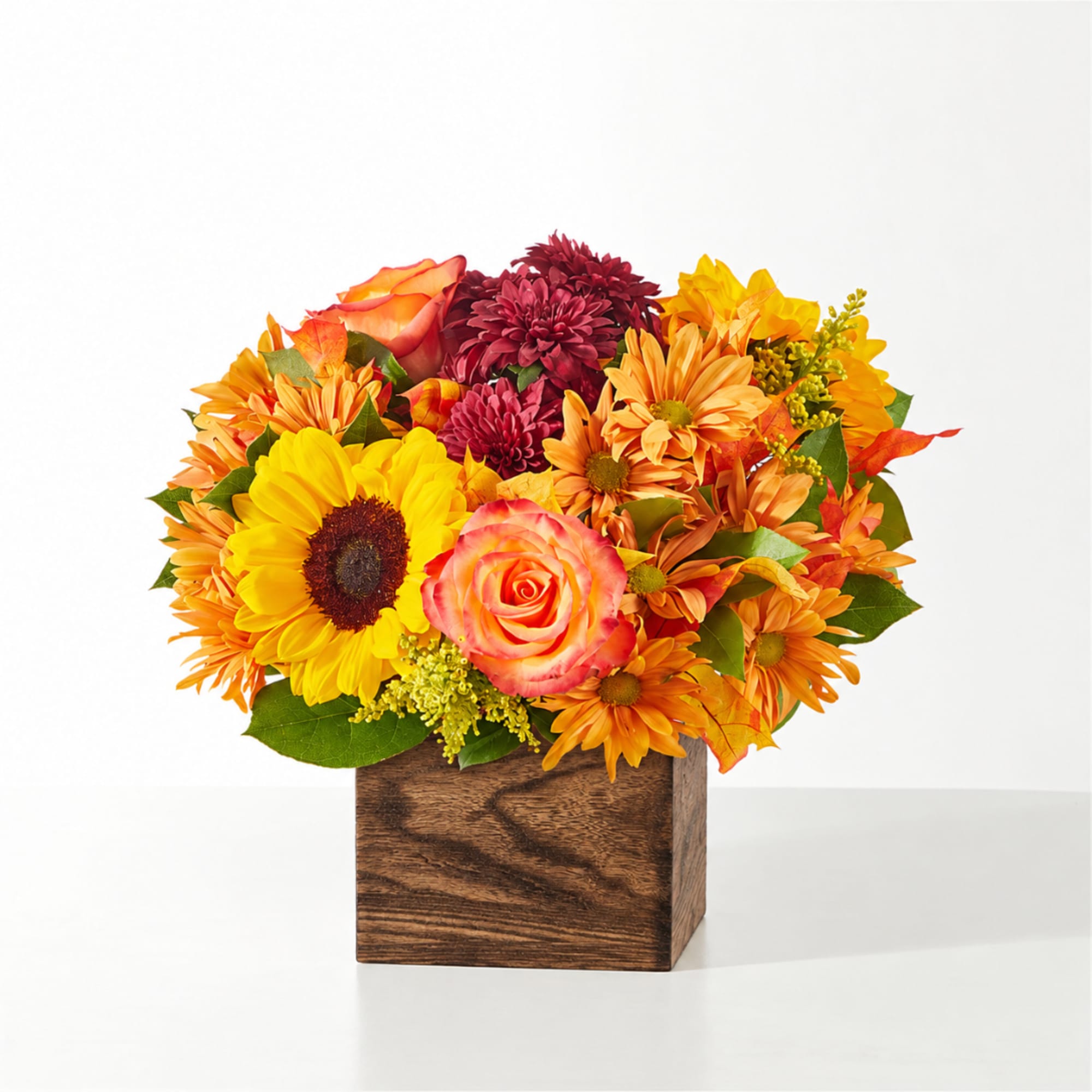 Mixed bouquet in a wooden cube vase with sunflowers and roses