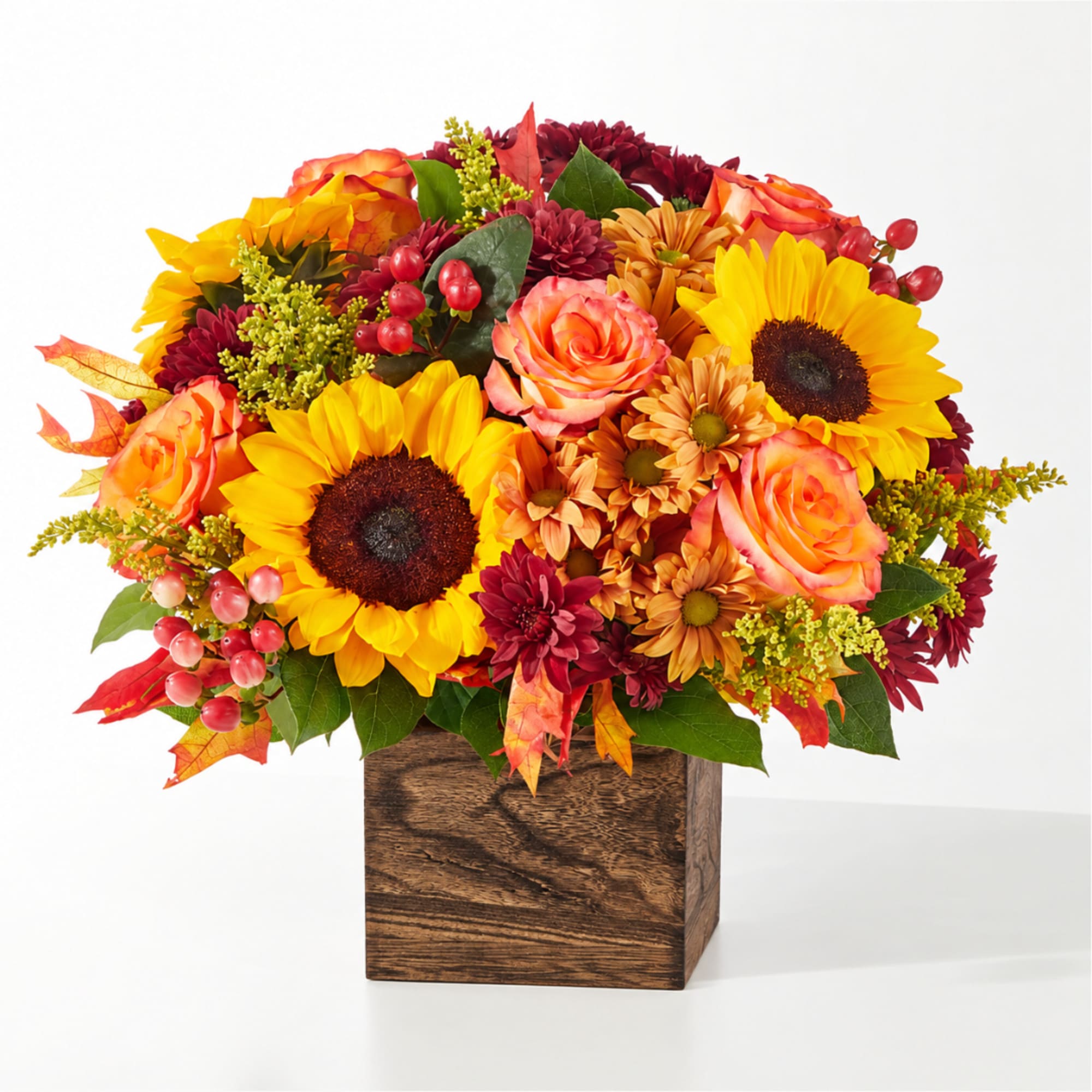 Autumn bouquet with sunflowers, roses, and mums in a wooden box