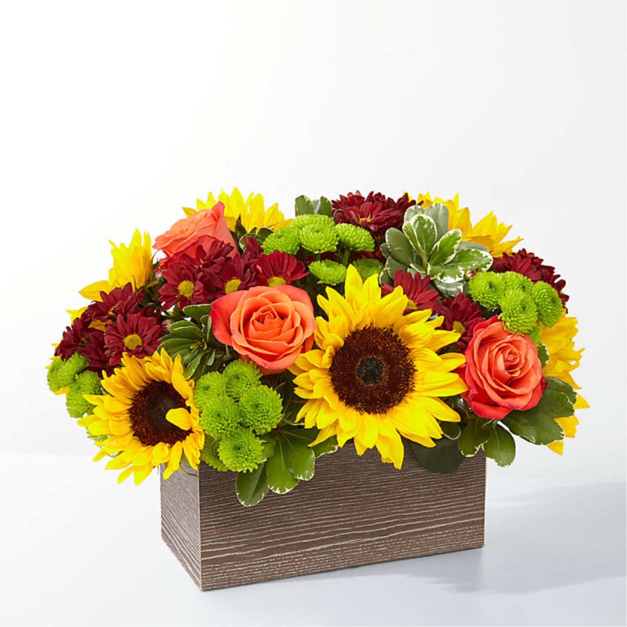 Sunflowers, roses, and mums arranged in a rectangular wooden box