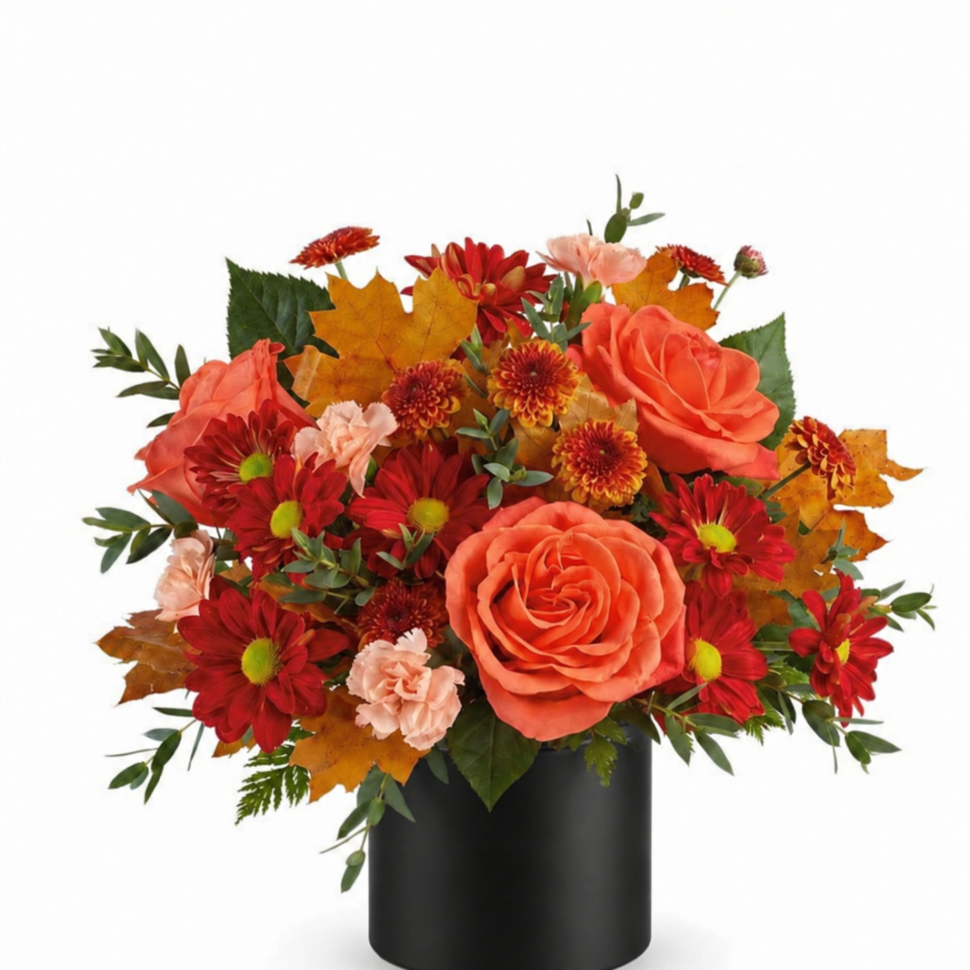Orange roses and red mums in a black vase with autumn leaves