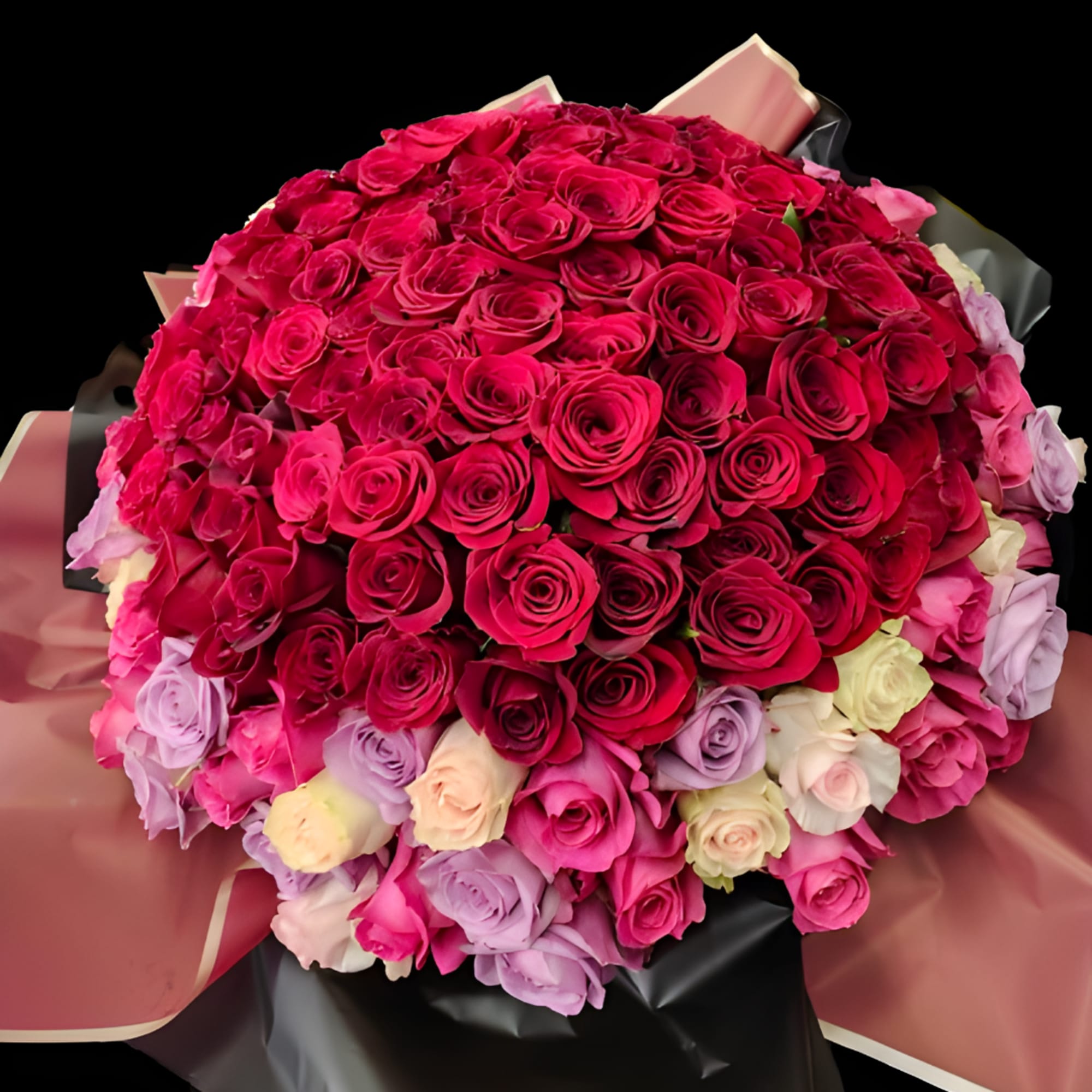 Large bouquet of pink and lavender roses wrapped in dark paper