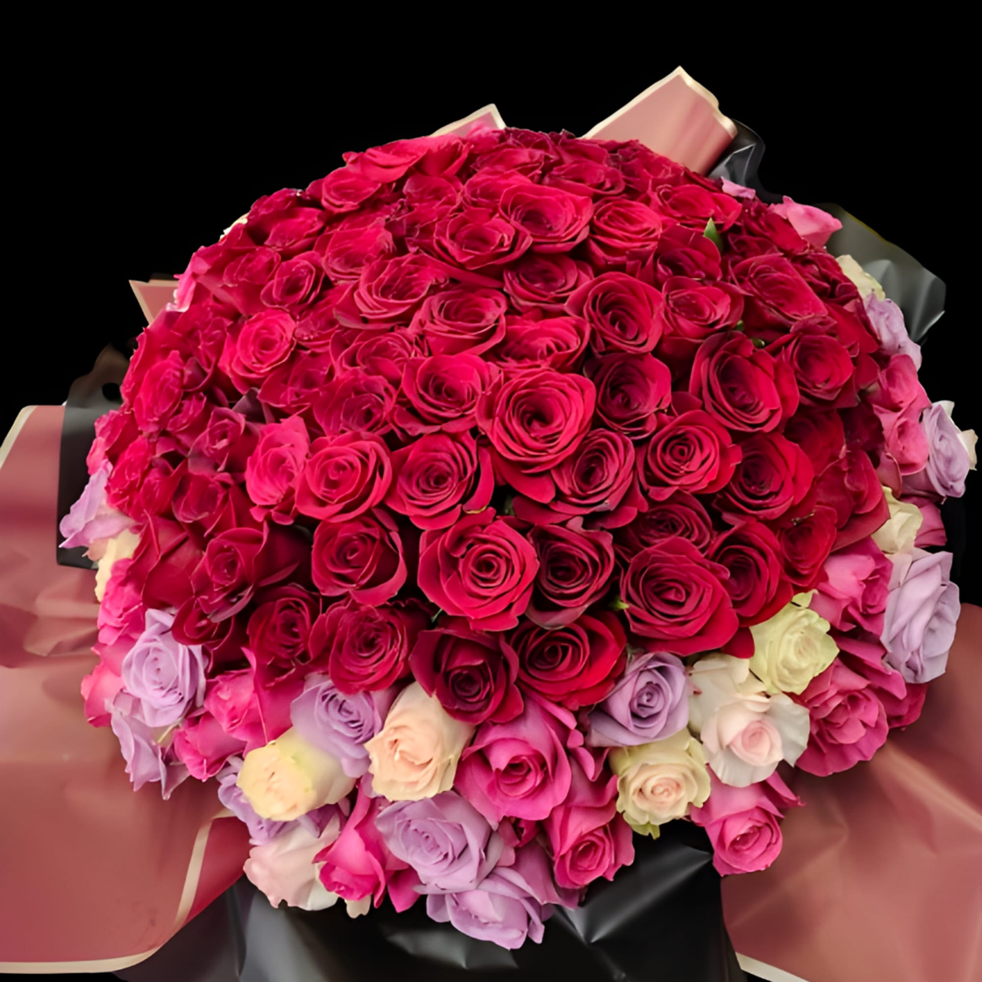 Large bouquet of pink and lavender roses wrapped in black and blush paper