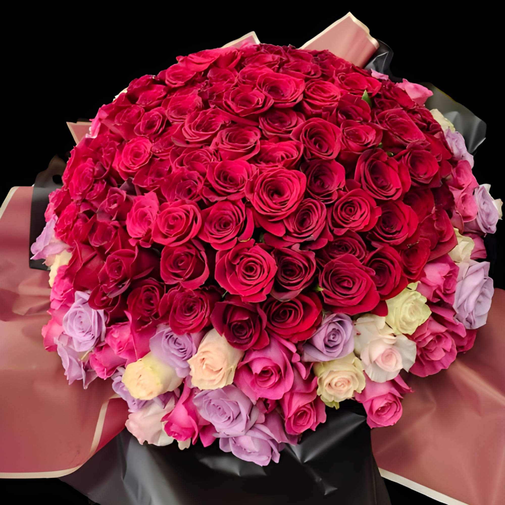 Large bouquet of pink and red roses with pastel roses wrapped in paper