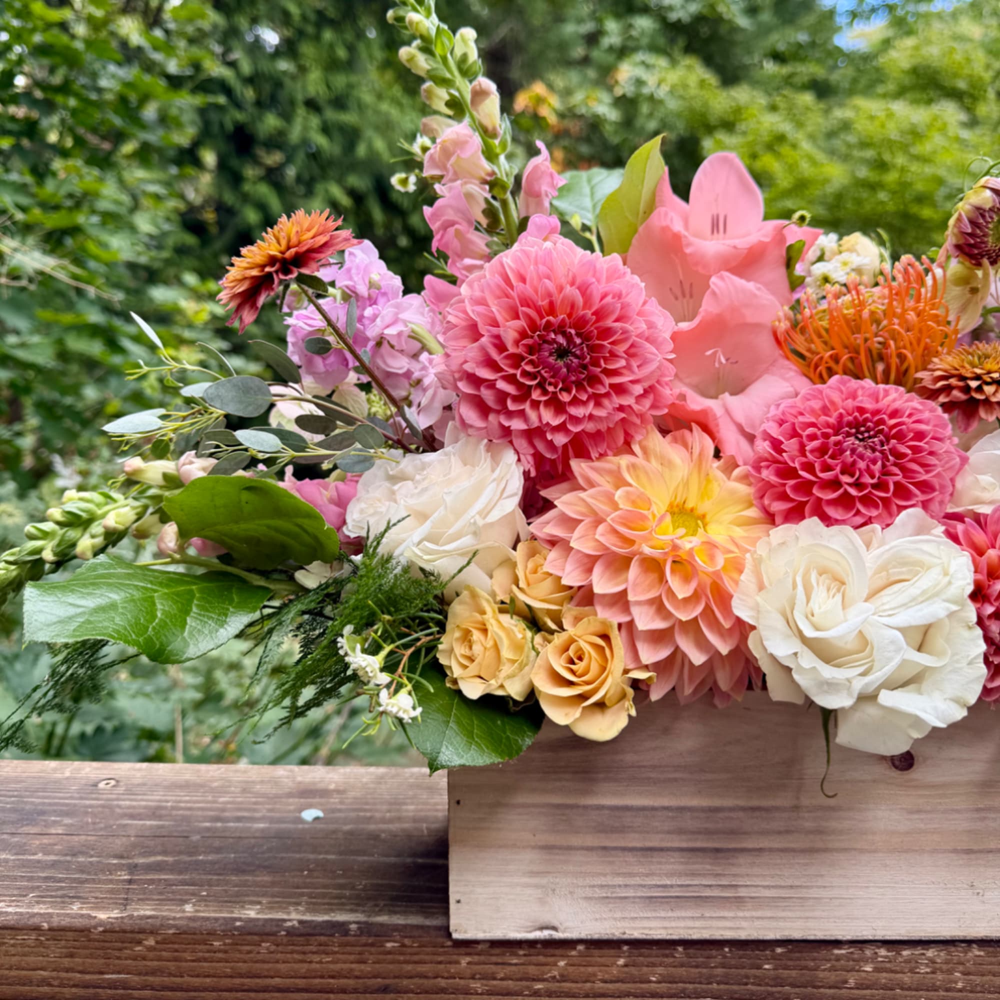 Pink and peach mixed bouquet in a wooden box