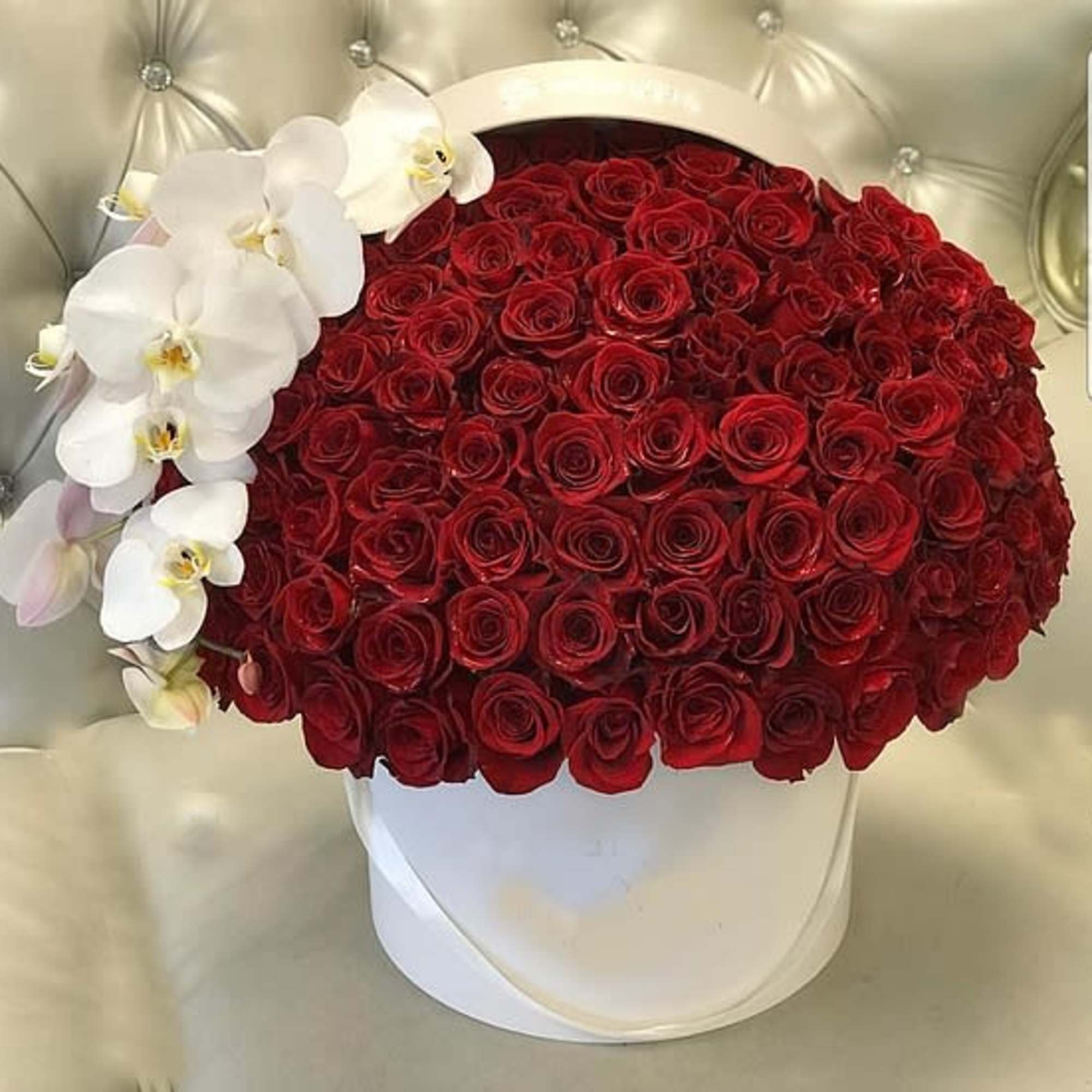 Red rose arrangement with white orchids in a white hat box