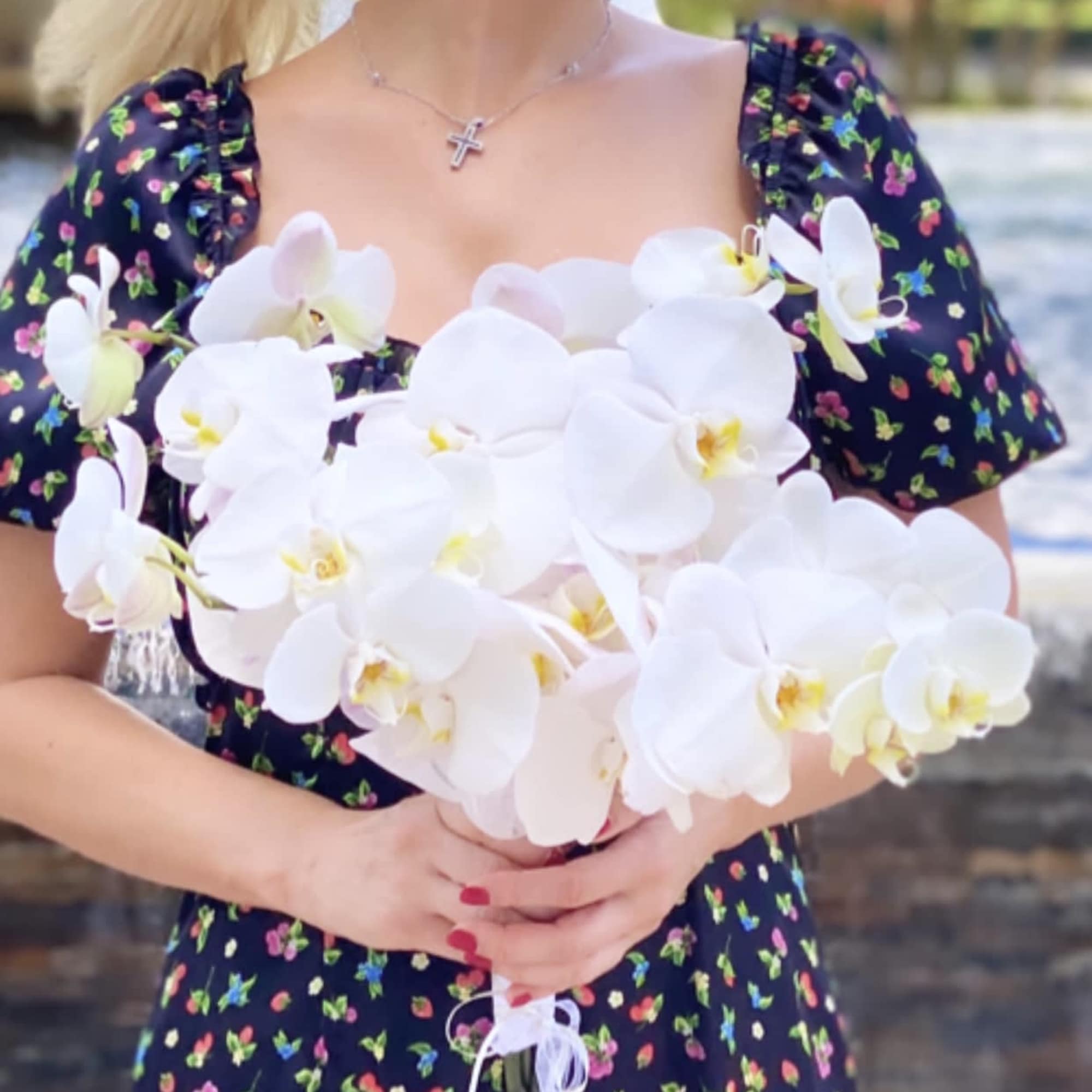 Woman holding a bouquet of white orchids