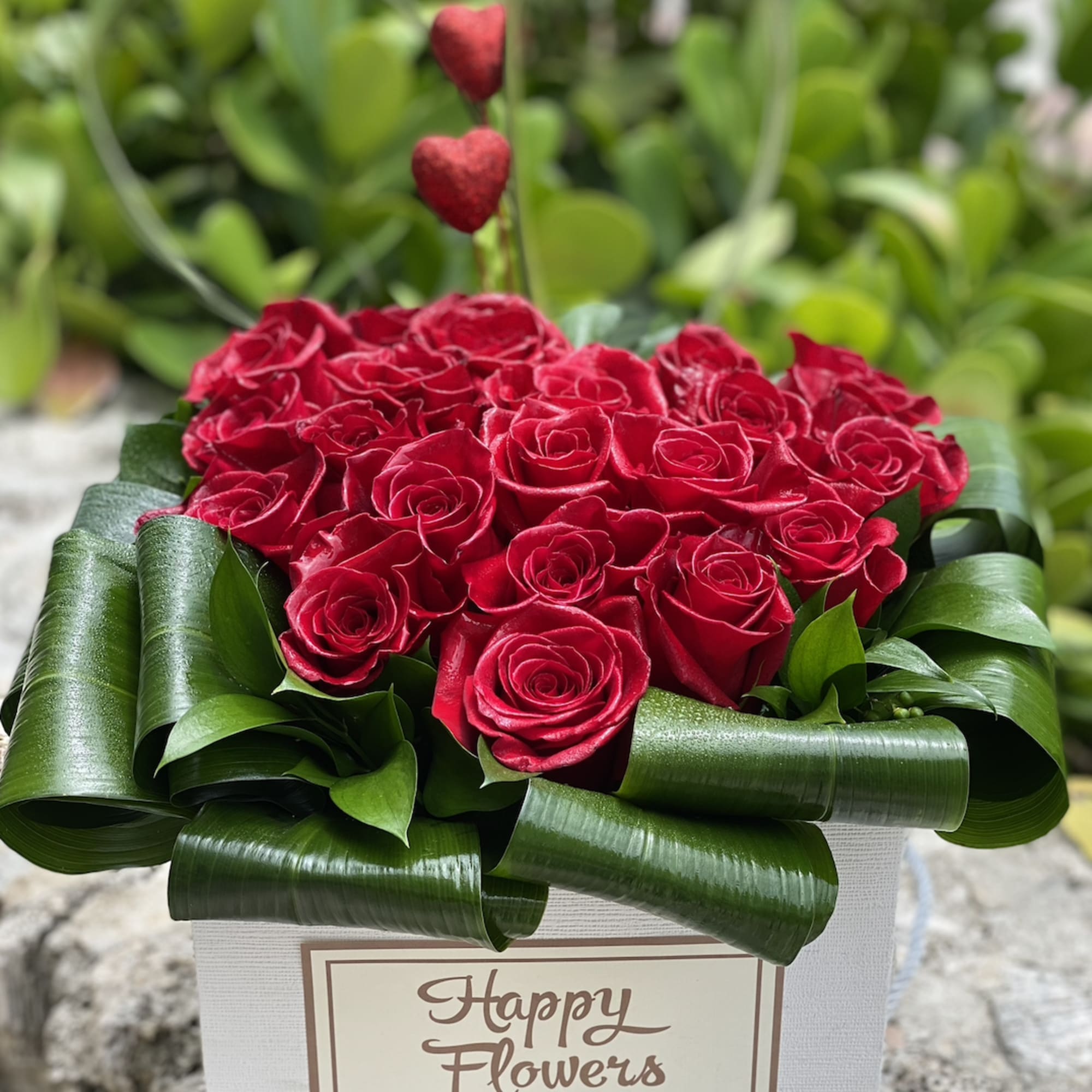 Red roses with greens and heard. A beautiful bouquet for the beautiful