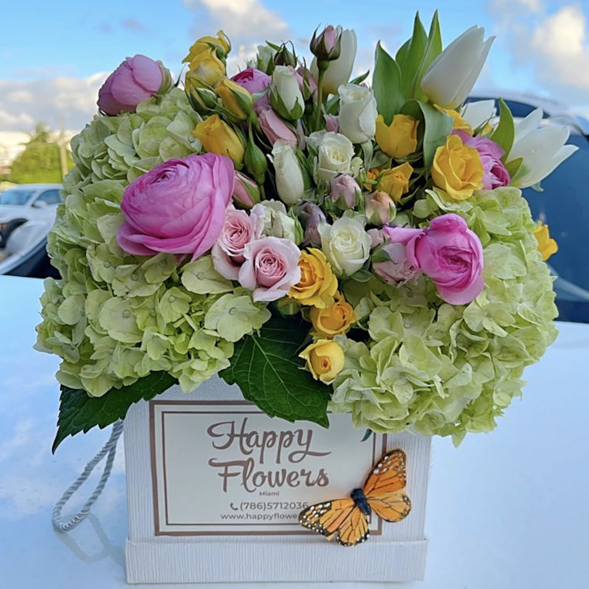 Beautiful flowers mix in a box. Hydrangea, tulips, spray roses and other